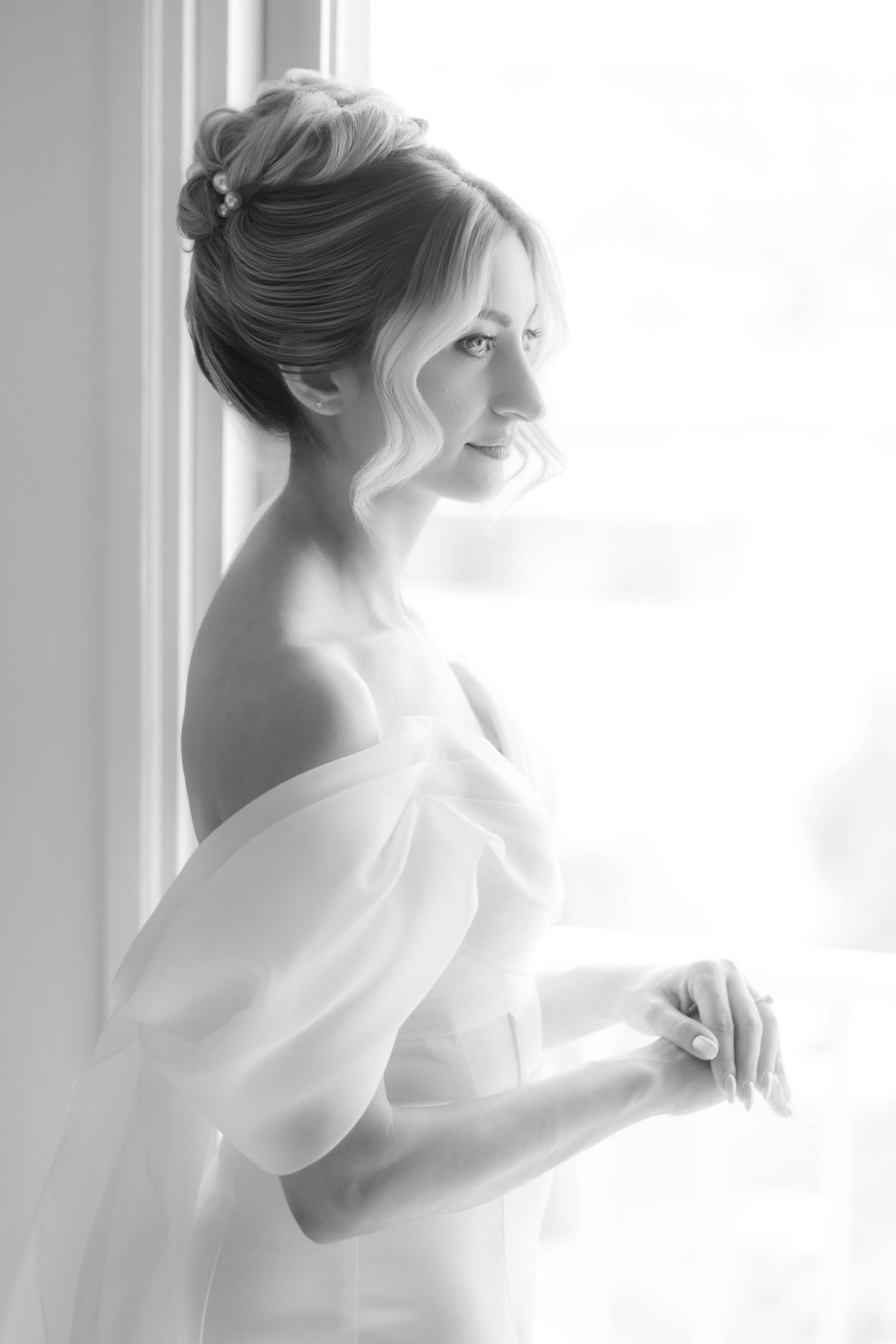 A dreamy series of four soft white photos showing silhouettes of a person in a bridal dress near a window.