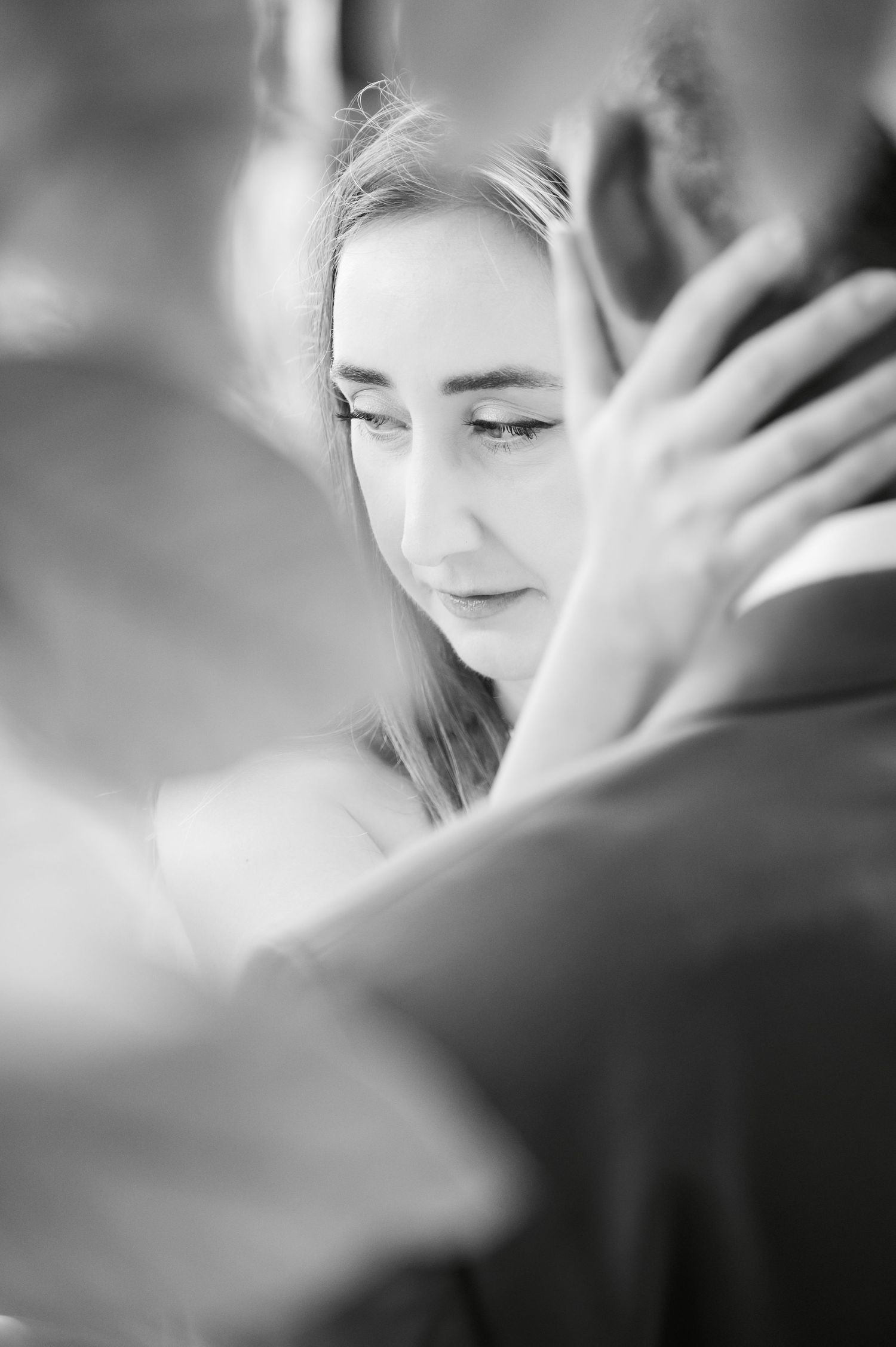 An intimate black and white portrait capturing a tender embrace.