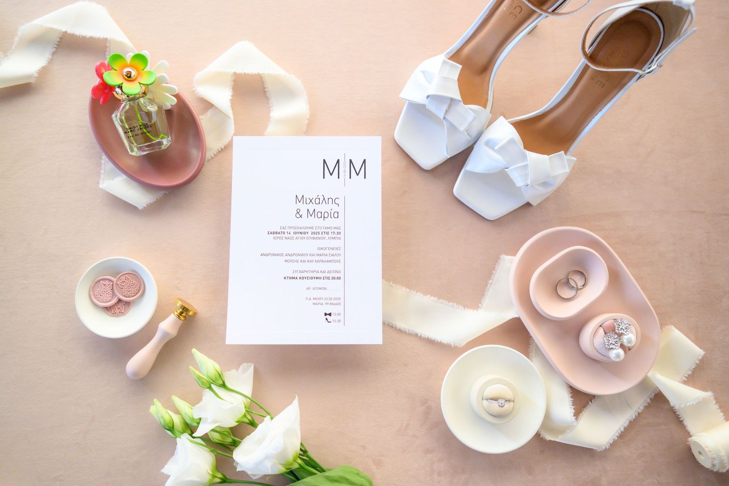 Pink roses and delicate place settings create an elegant wedding reception tablescape with soft blush tones.