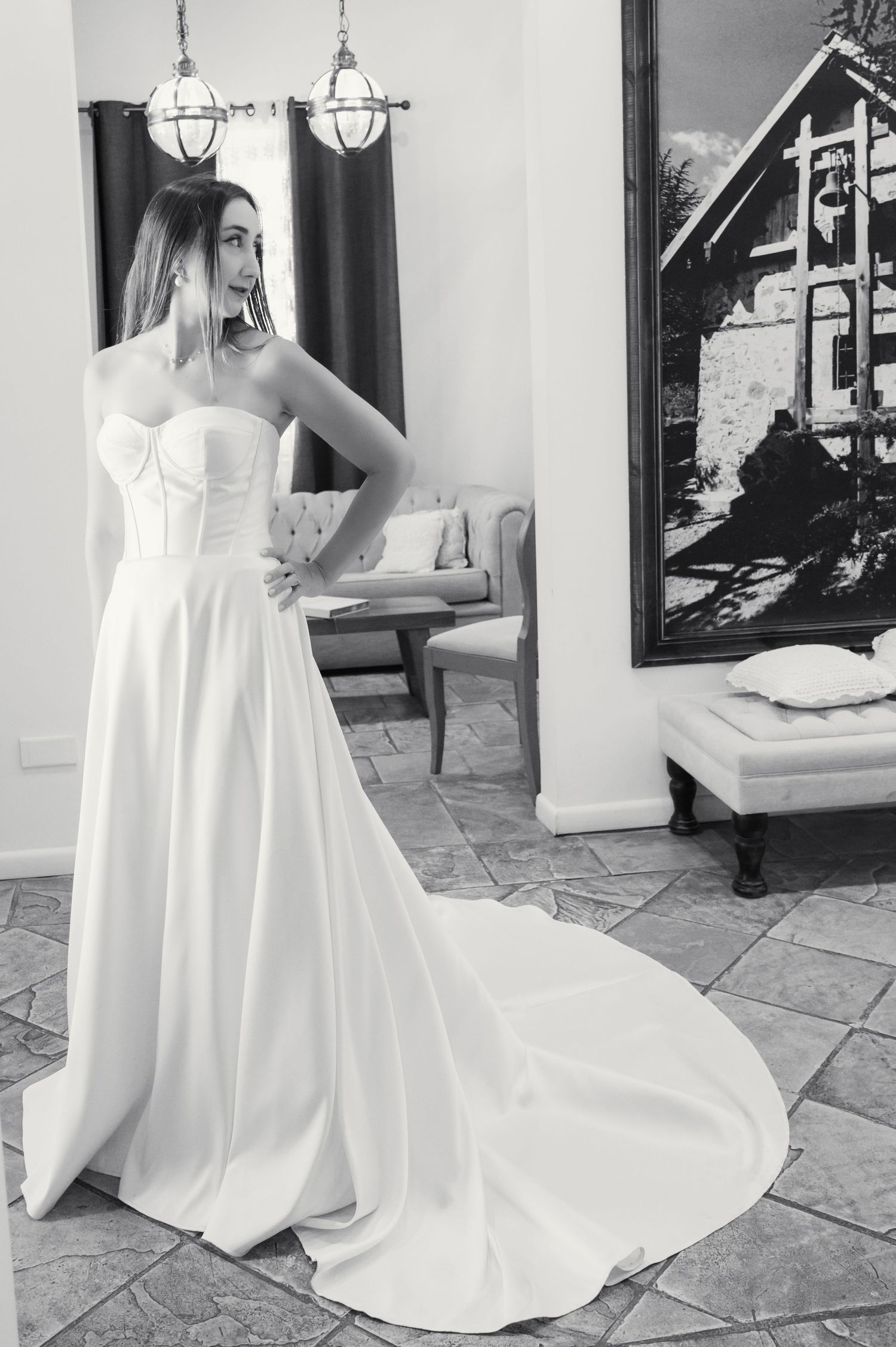 Black and white bridal portrait in elegant room with dramatic lighting.