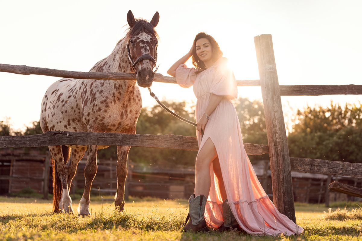 A horse and a person shares a moment at sunset photoshoot in sydney