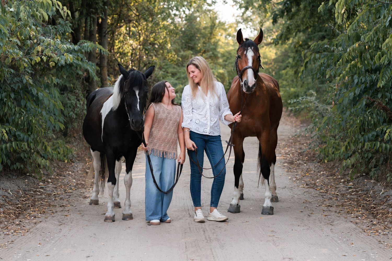 mom and daughter in an alley in their private property on Cattai Sydney during a family photoshoot with their horses