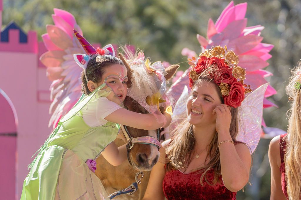 girl hugging a unicorn pony while her sister is a fairy holding the pony during a photoshoot in Sydney