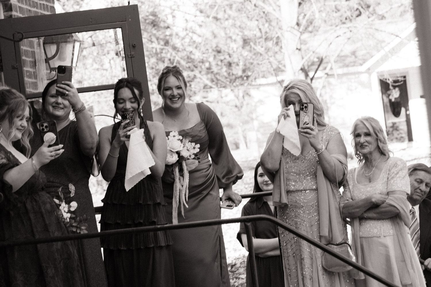 Family crying while watching a first look between the bride and groom at a wedding at Walnut Hall Estate in Carrollton, Illinois.