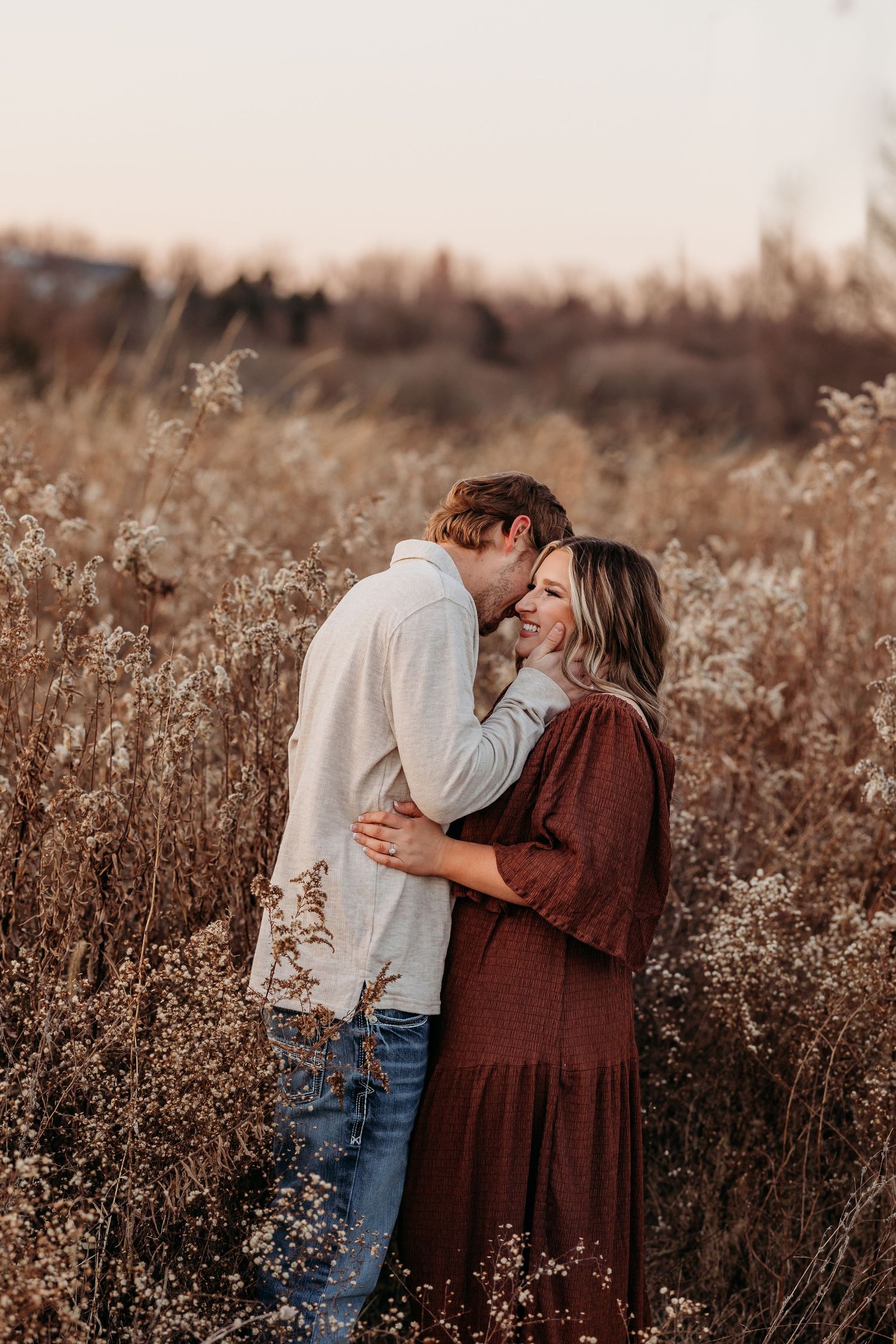 Romantic sunset portrait in autumn field with warm golden lighting.