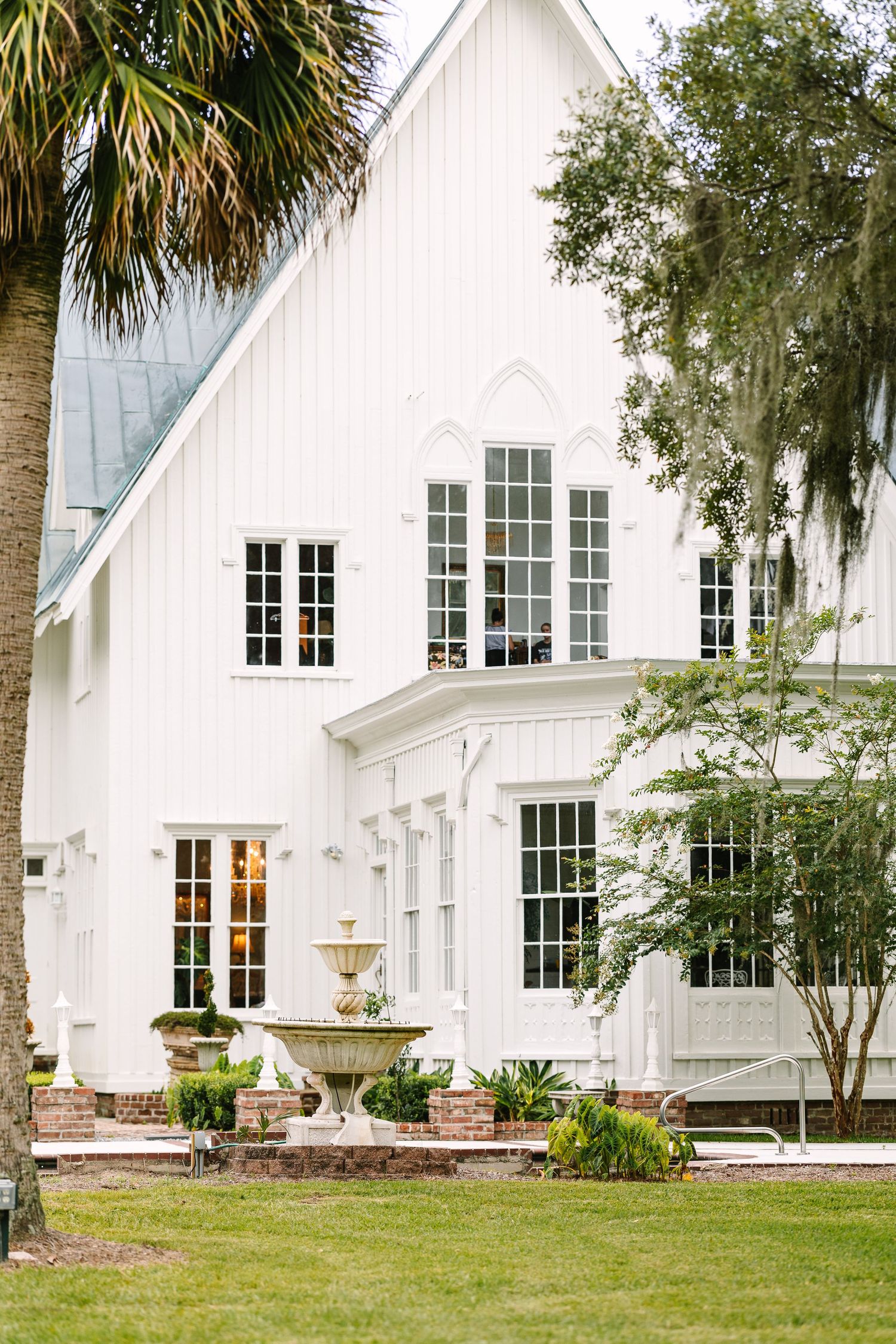 A white Southern plantation-style building with tall windows and elegant architectural details.
