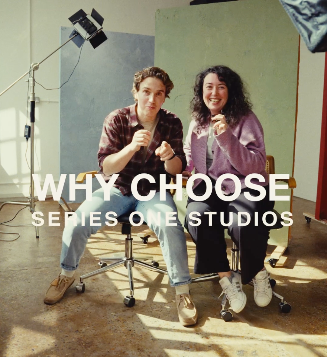 Two people sit smiling in a photography studio with the text Why Choose Series One Studios overlaid.