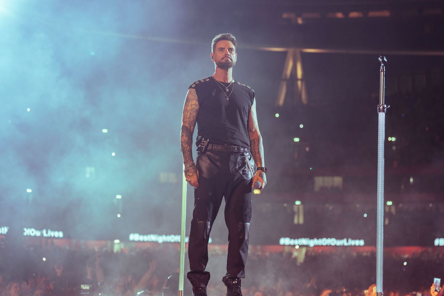Keith Duffy performer standing on stage under dramatic blue concert lighting. Dave Martin Photography Northern Ireland