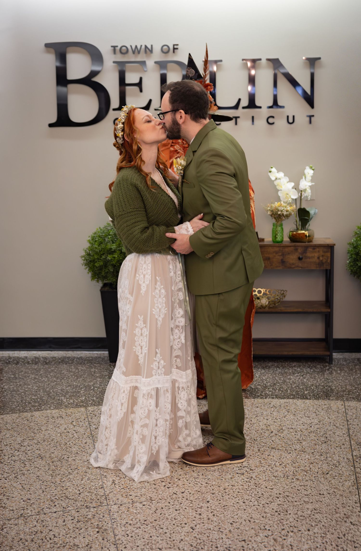 Bride and groom kissing in front of the Town of Berlin Connecticut sign during their courthouse wedding.