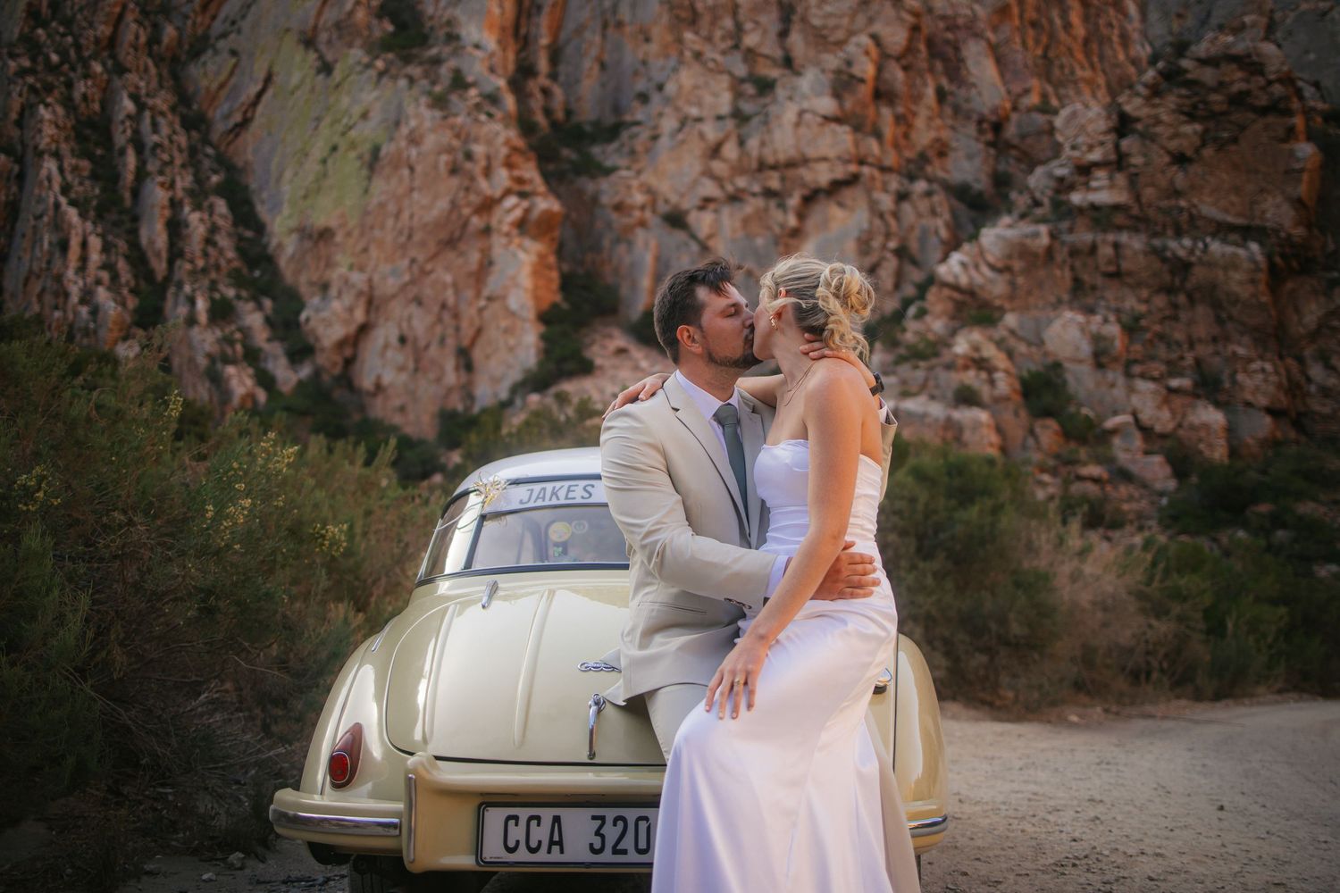 Wedding photography by Crimson and Vow showing a bride and groom hugging at a scenic wedding venue in George, Garden Route.