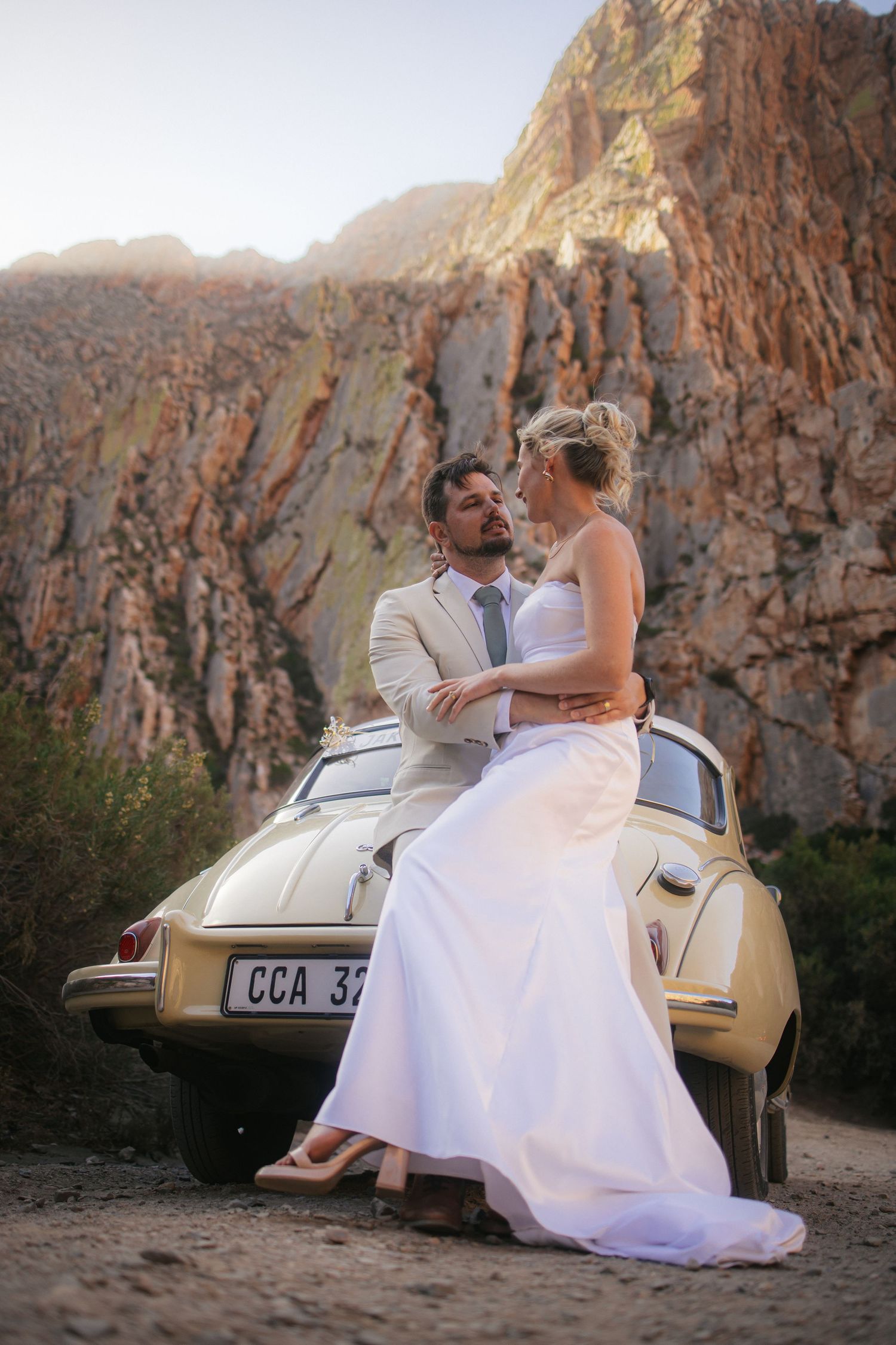 Wedding photography by Crimson and Vow showing a bride and groom hugging at a scenic wedding venue in George, Garden Route.