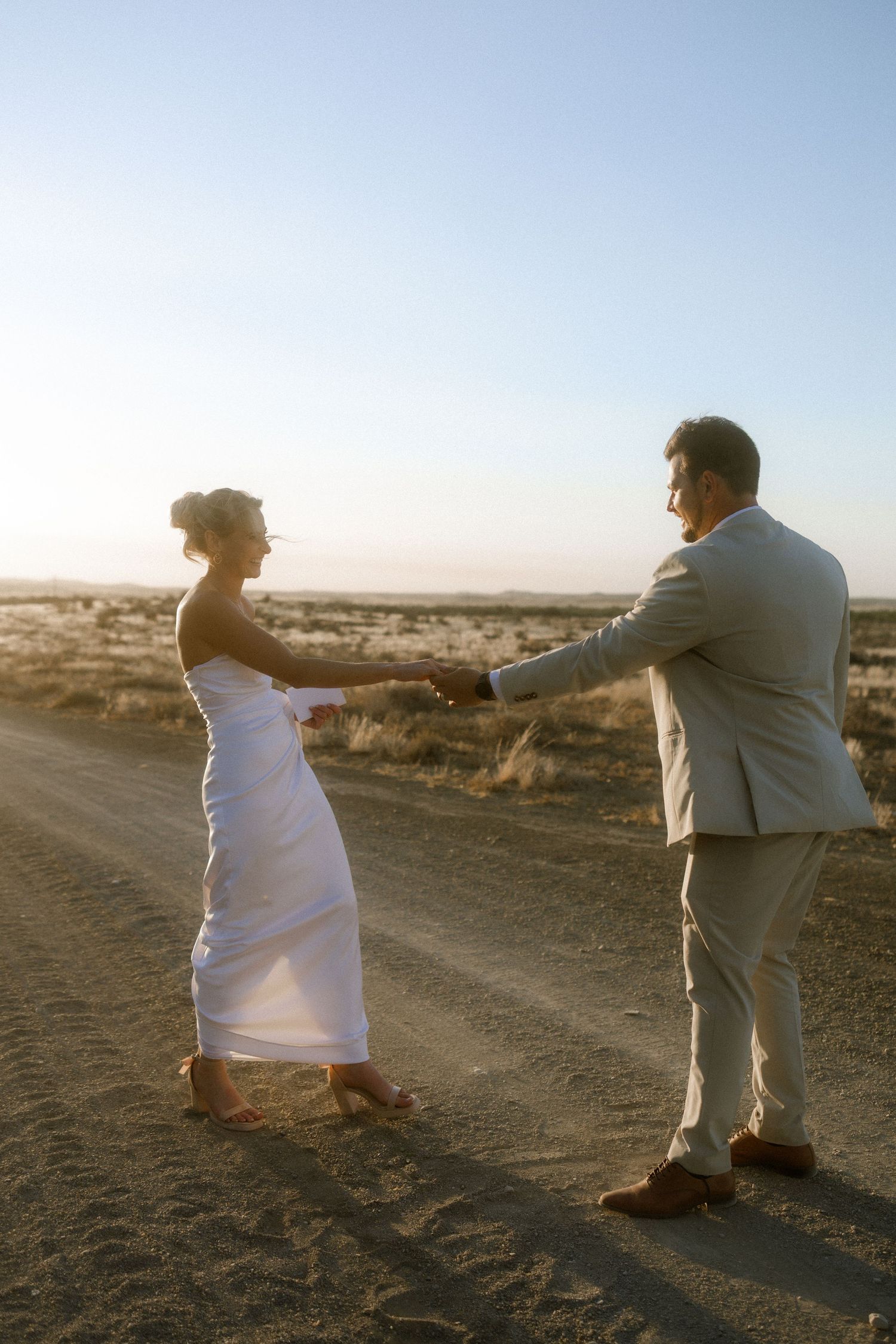Wedding photography by Crimson and Vow showing a bride and groom hugging at a scenic wedding venue in George, Garden Route.