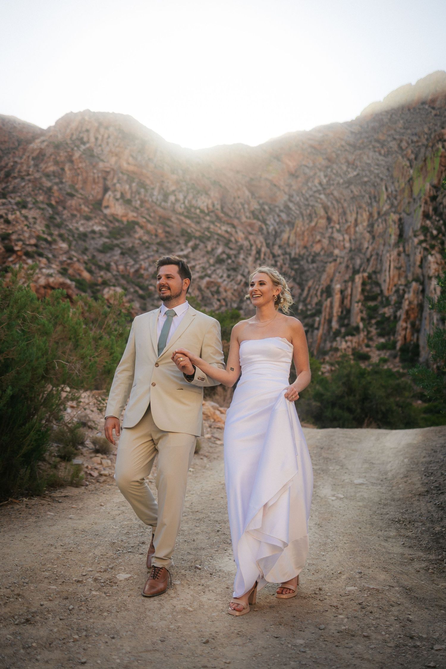 Wedding photography by Crimson and Vow showing a bride and groom hugging at a scenic wedding venue in George, Garden Route.