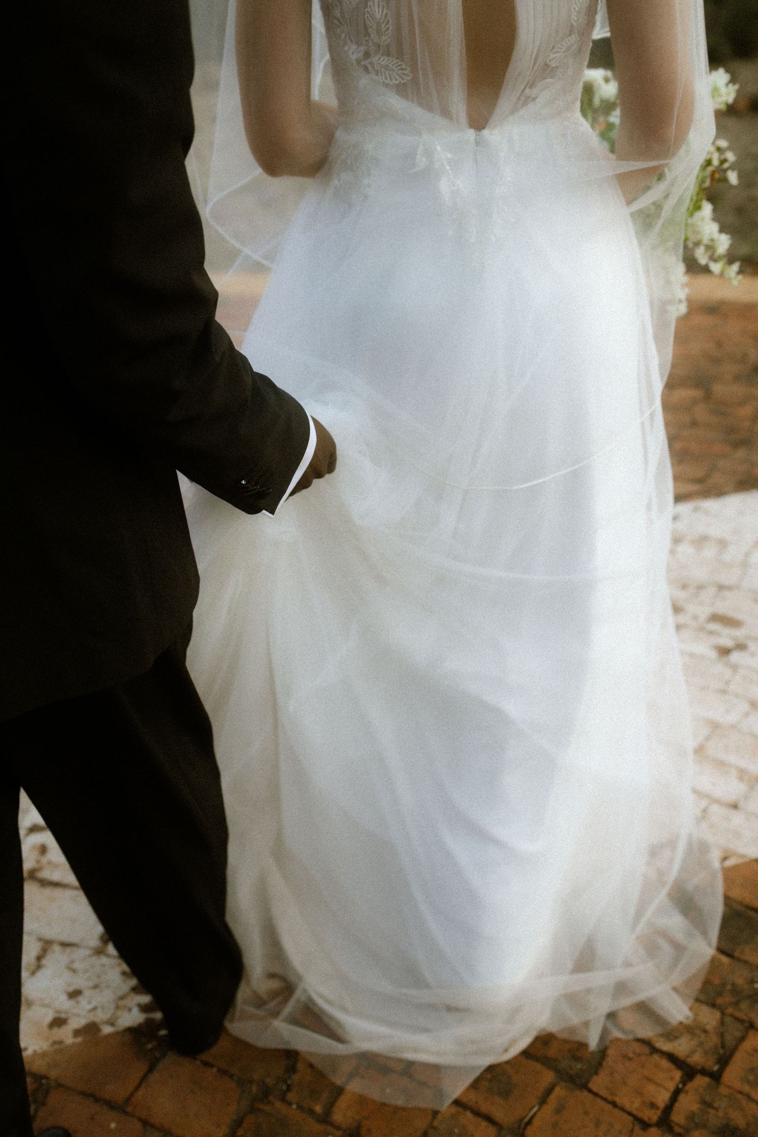 Wedding photography by Crimson and Vow showing a bride and groom hugging at a scenic wedding venue in George, Garden Route.