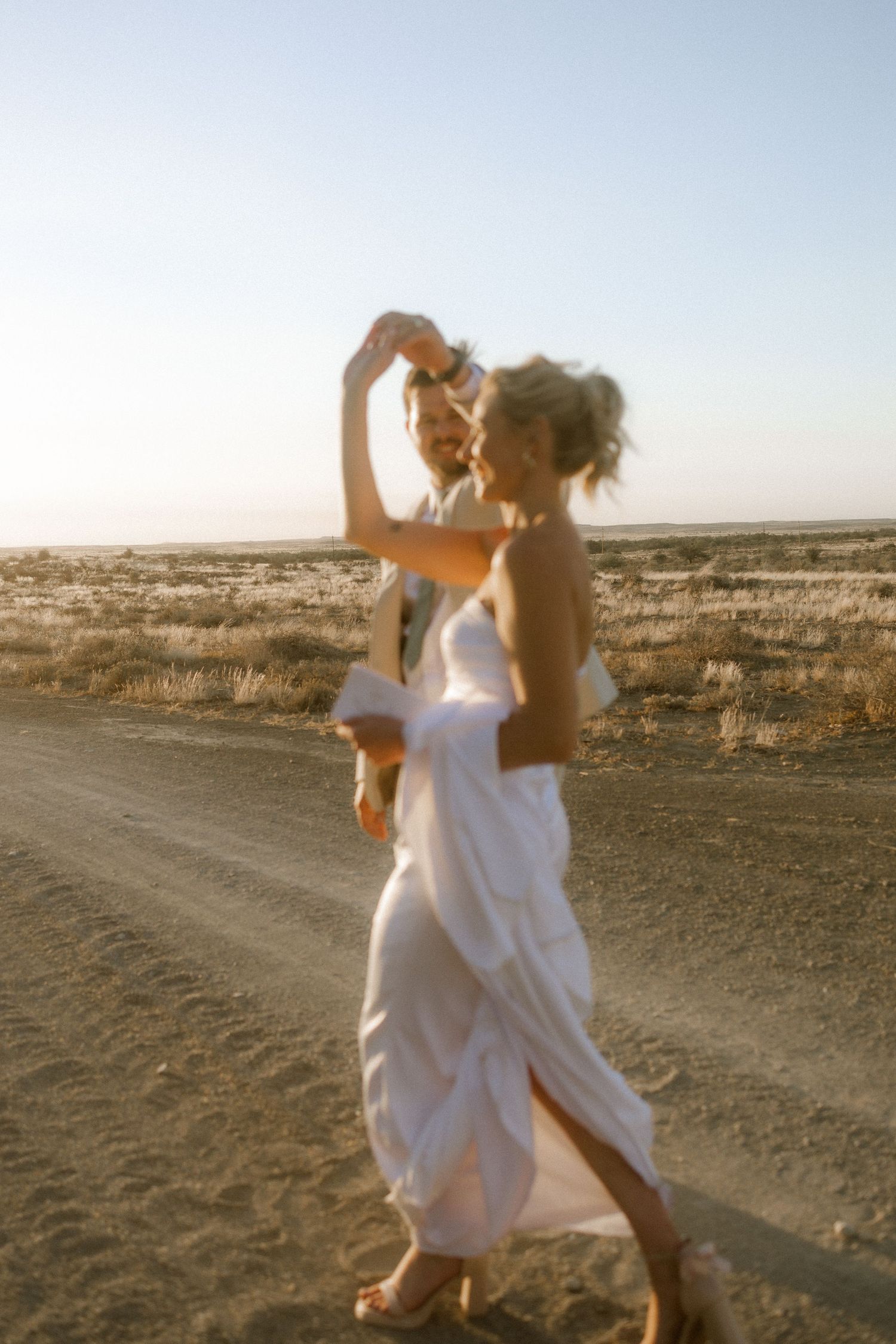 Wedding photography by Crimson and Vow showing a bride and groom hugging at a scenic wedding venue in George, Garden Route.