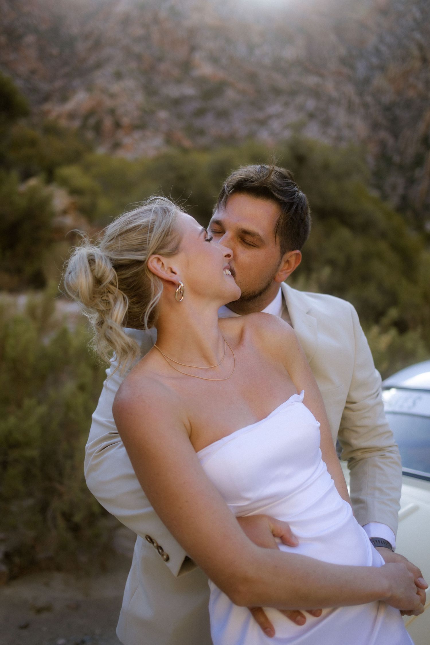 Close-up wedding photography by Crimson and Vow showing the bride's white dress details at a venue in Plettenberg Bay