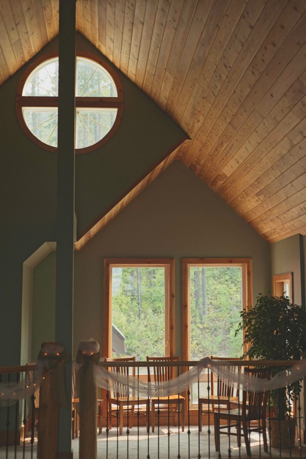 Interior space of the wedding venue showcasing windows and a wooden ceiling.
