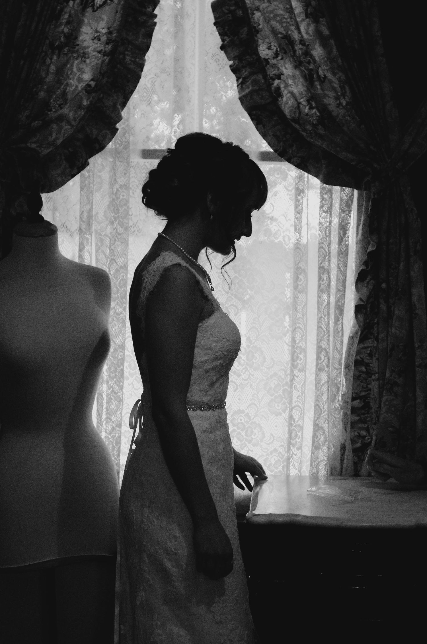 Black and white photo of the bride having a moment to herself before the ceremony.