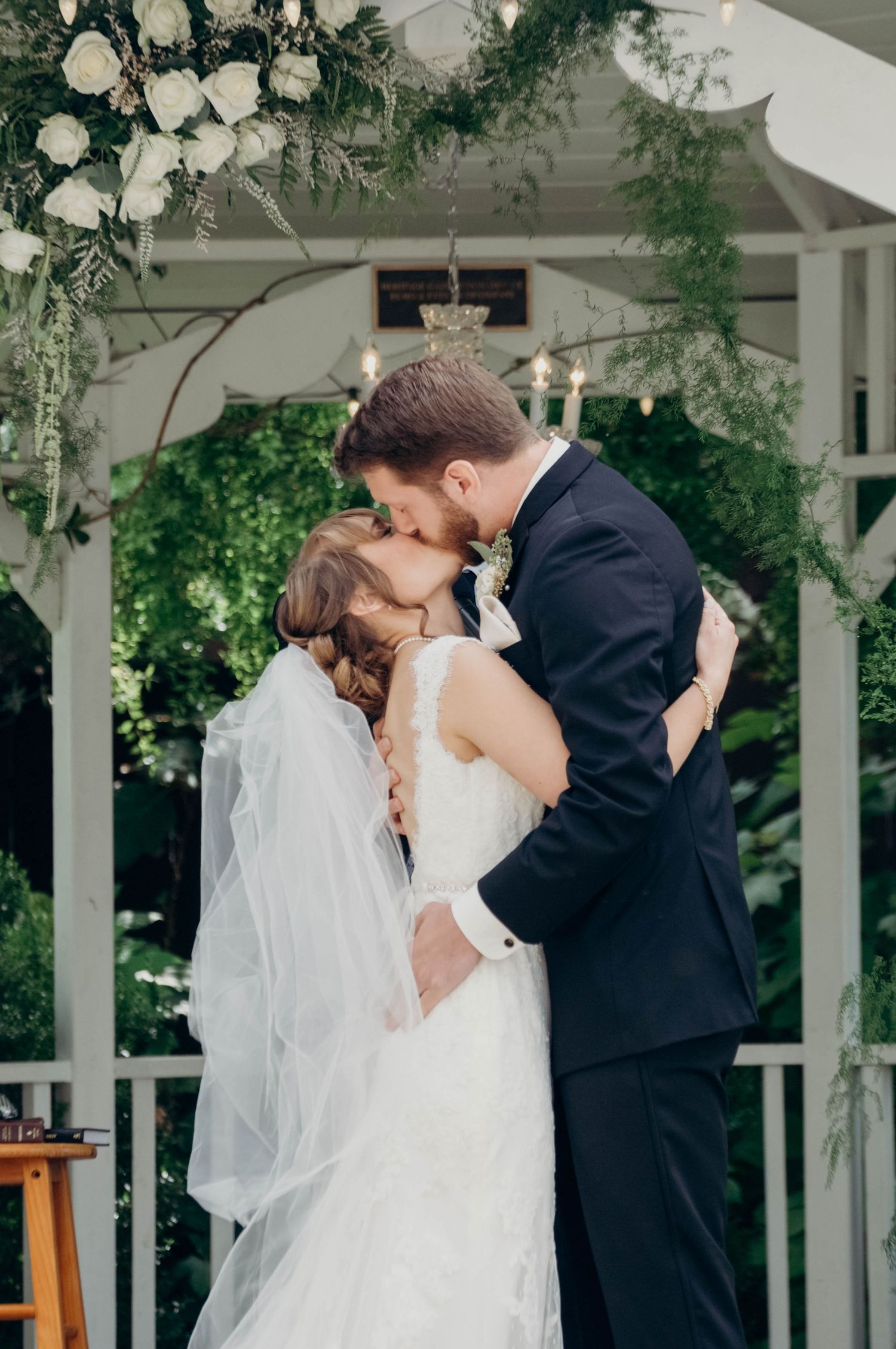 Bride and groom share their first kiss as a married couple during the wedding ceremony.
