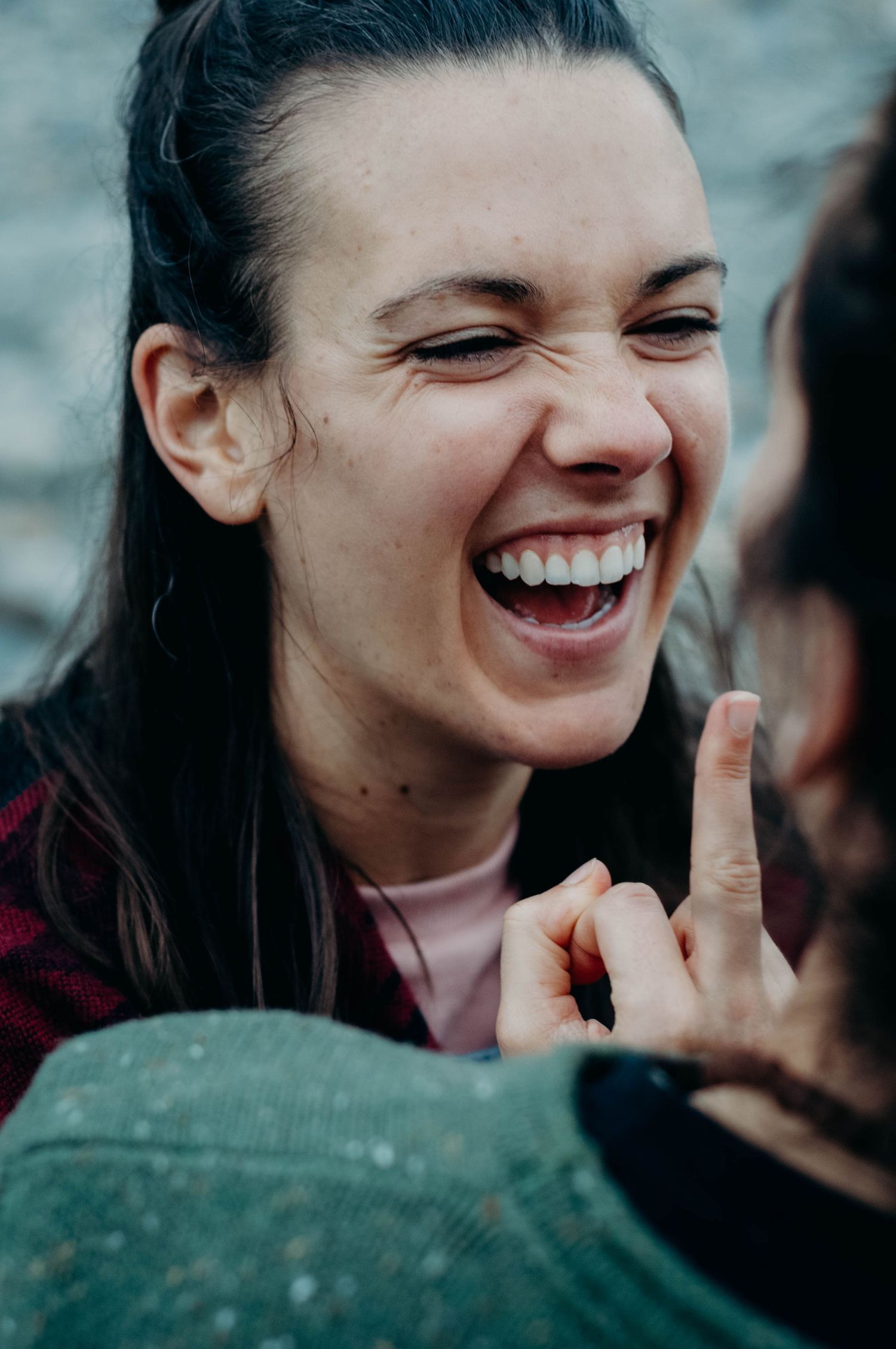 Fiancee smiles and flips the bird after being teased by her partner.