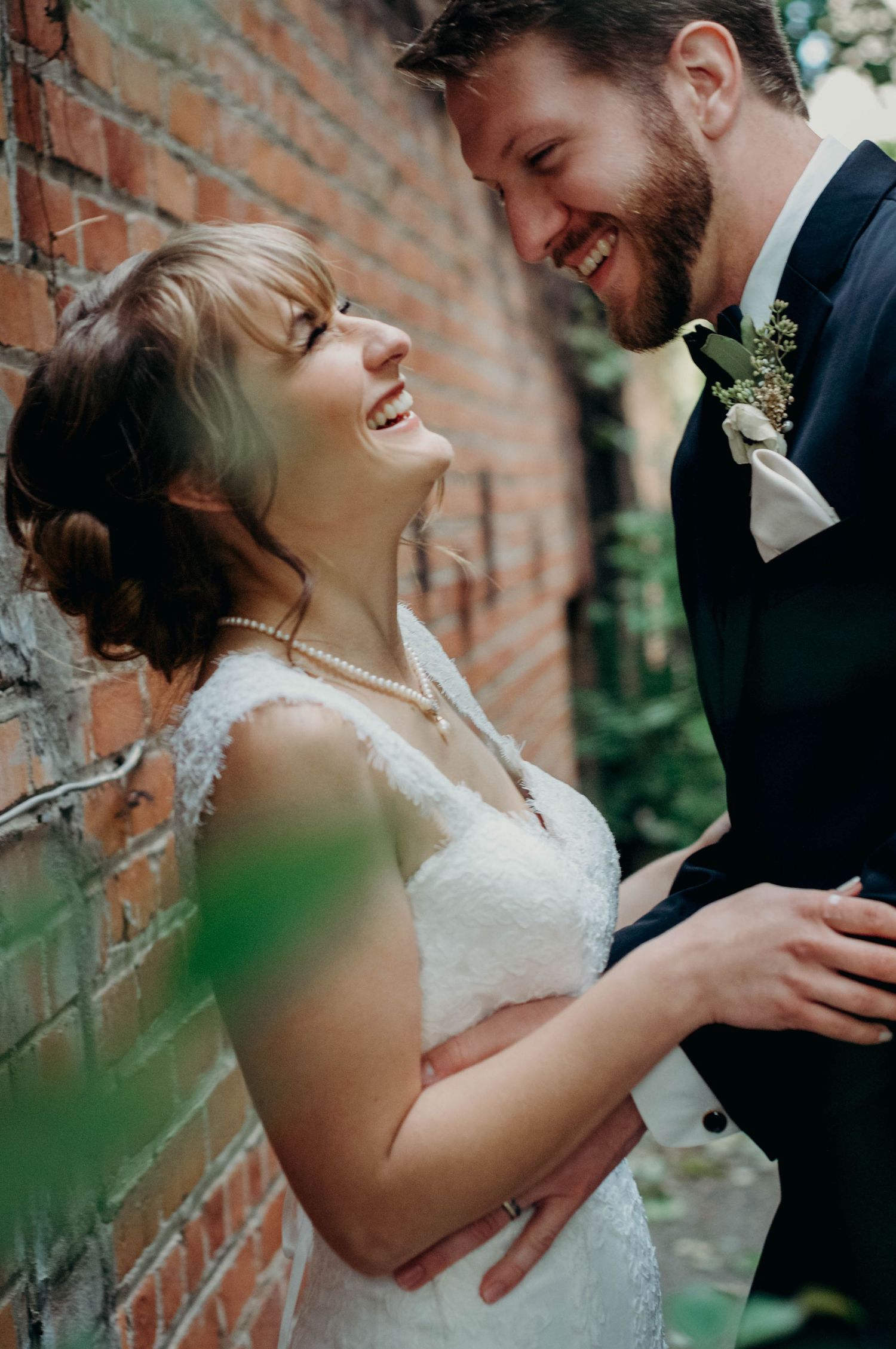 Bride and groom laugh together after their wedding ceremony.
