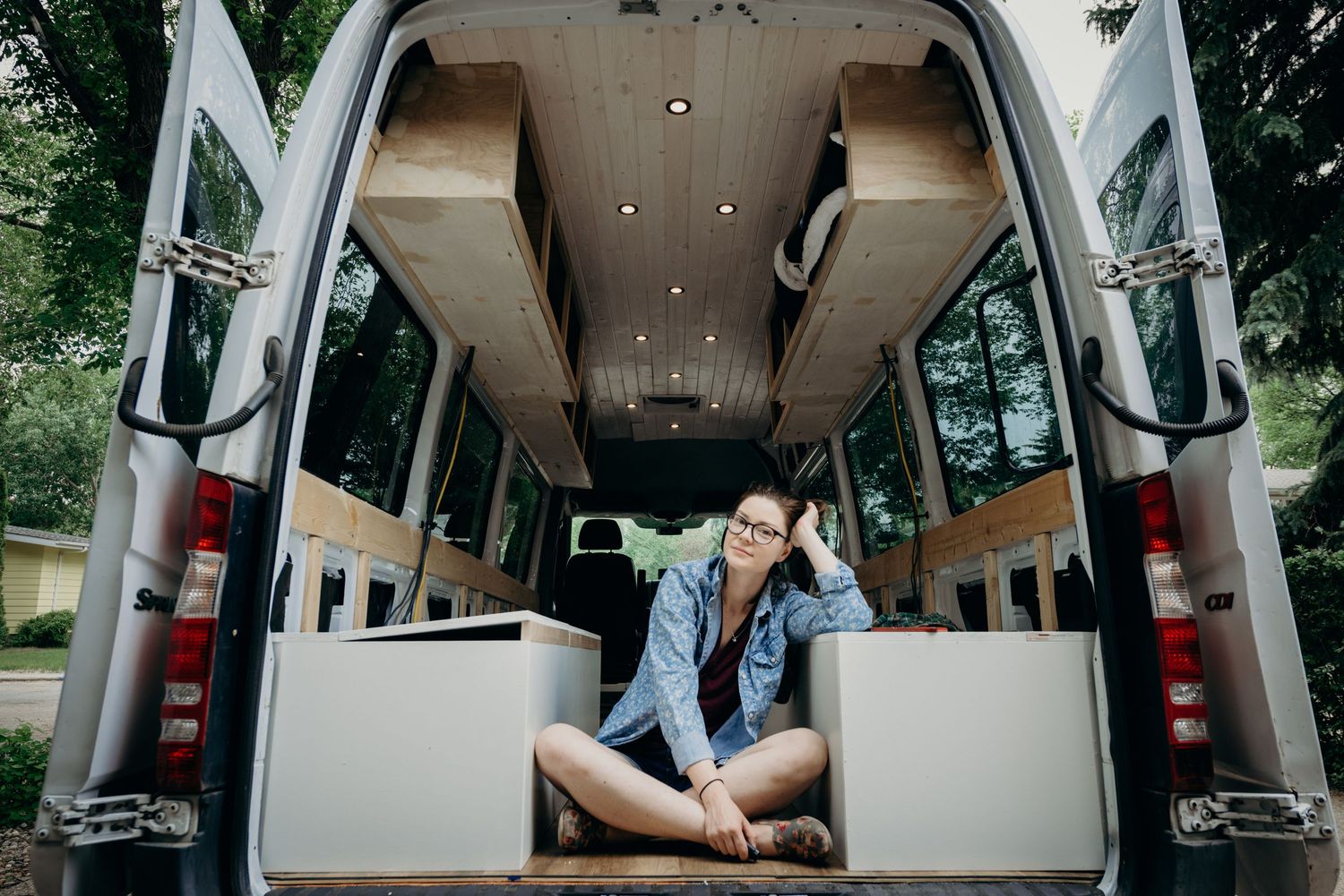 Photographer smiles at camera from her home on wheels.