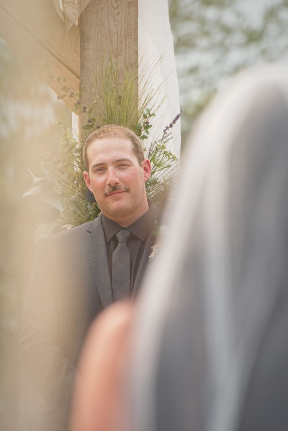 The groom watching his bride walk down the aisle.