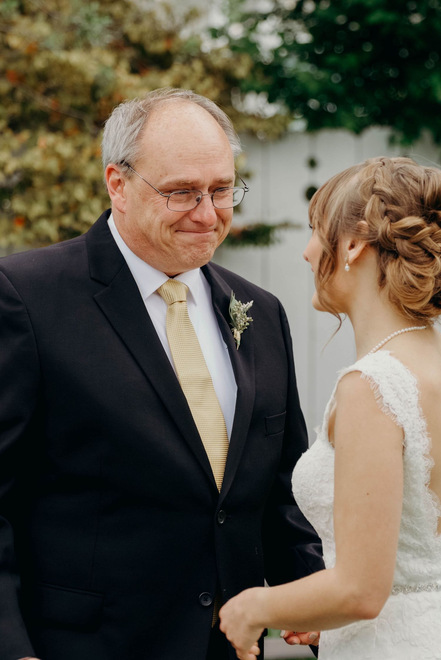 Bride's father tearing up looking at his daughter before the ceremony.