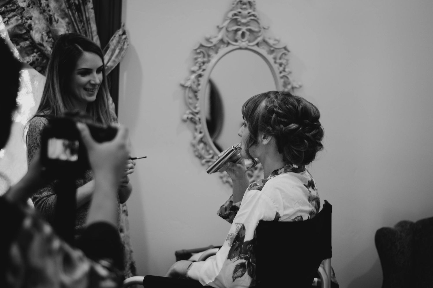 Bride getting her hair and makeup done before the wedding.