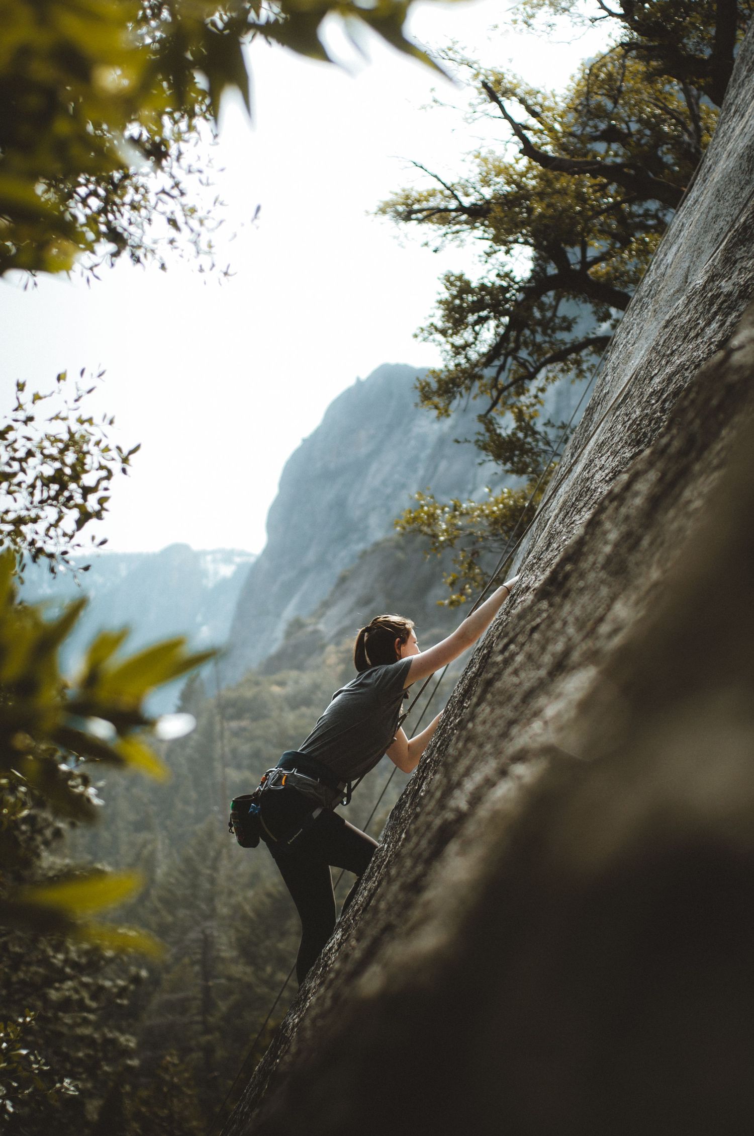 Photographer rock climbing in Yosemite National Park, California.