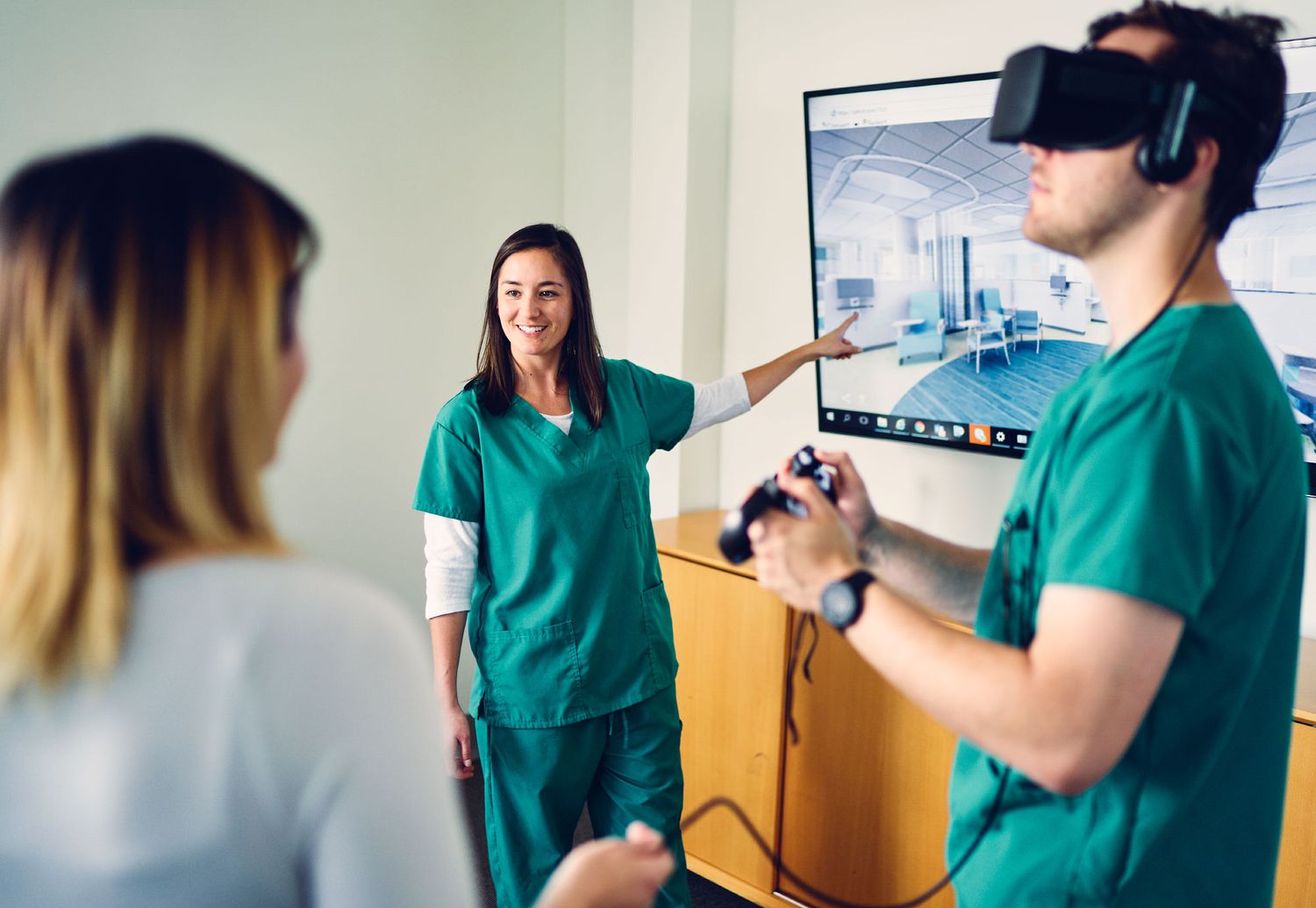 Medical professionals in scrubs exploring virtual reality technology in a healthcare setting.