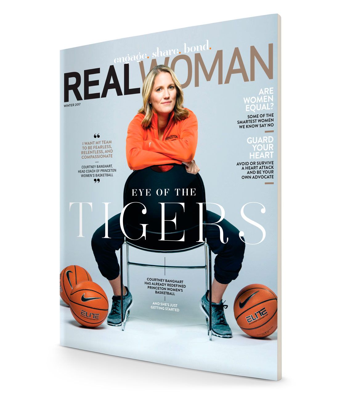 Real Woman magazine cover featuring a woman seated with basketballs and headline Eye of the Tigers.