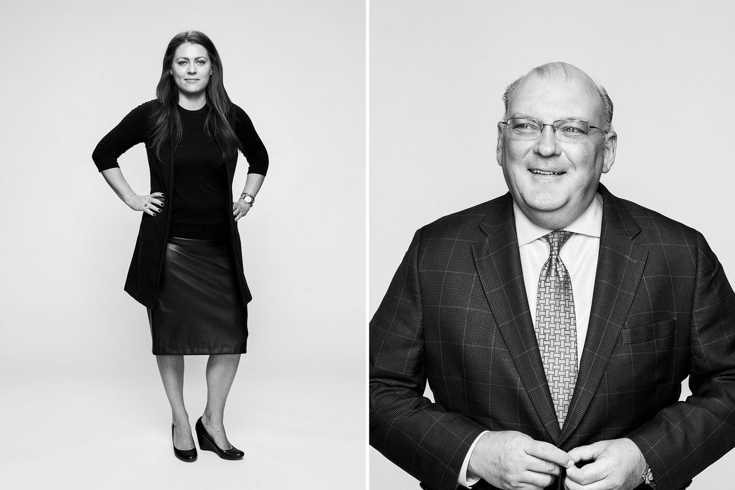 Professional woman in black outfit and businessman in suit pose in black and white portraits.