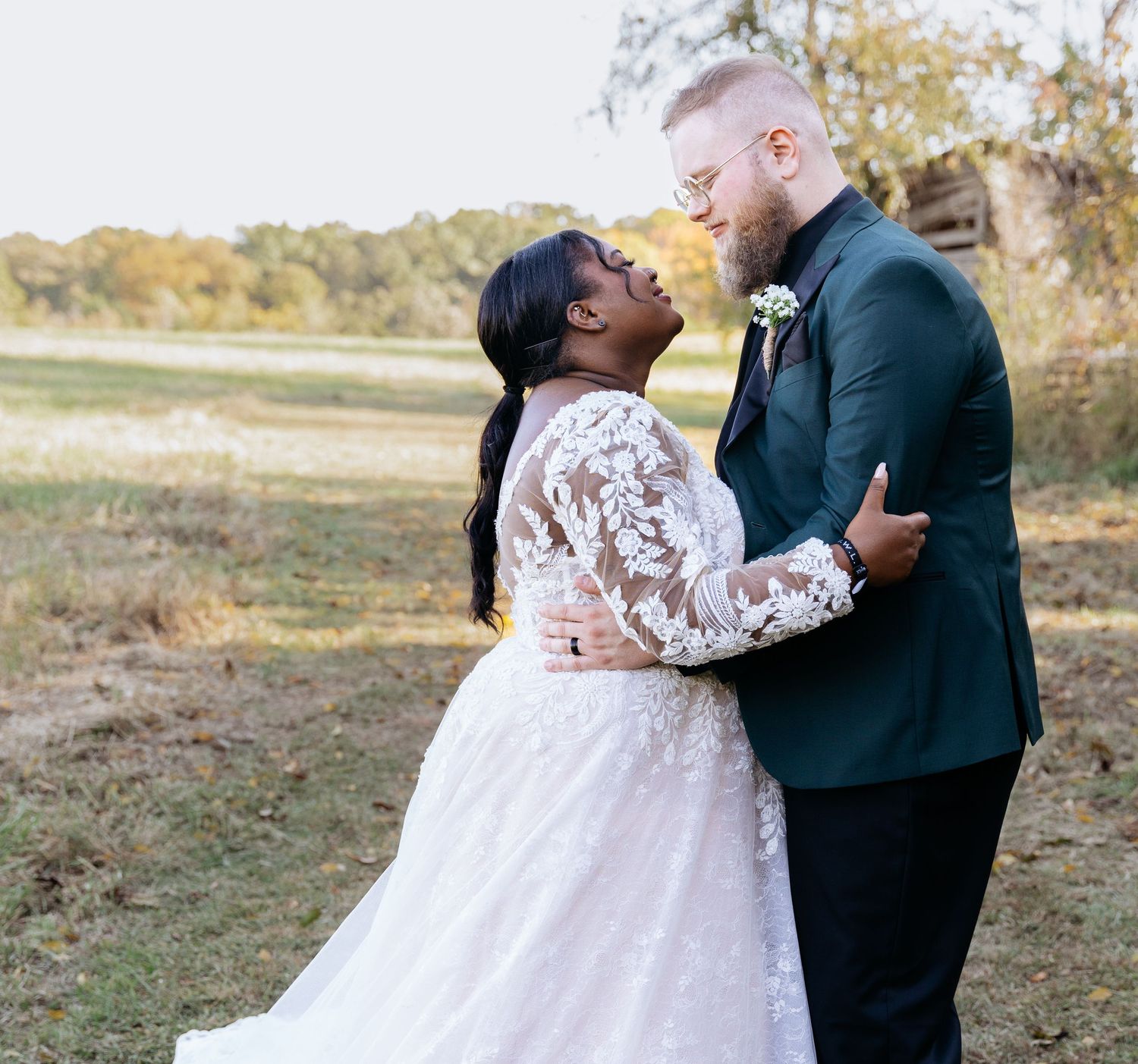 Outdoor wedding photography with individual couples photoshoot. Couple holding each other with bride wearing wedding dre