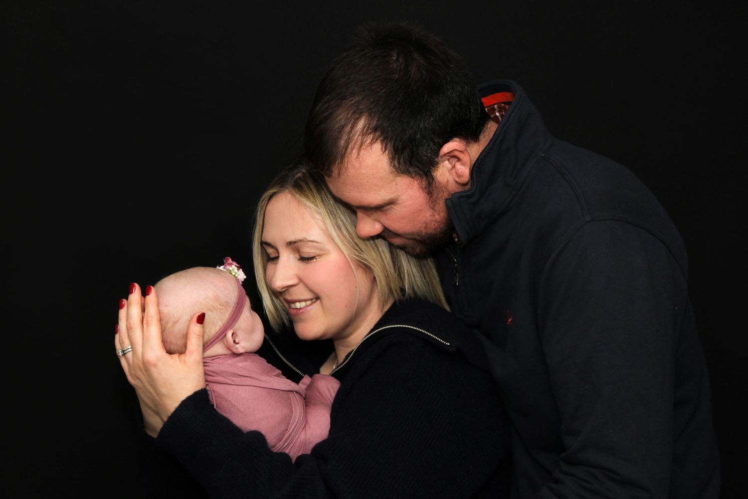A sequence of intimate silhouettes showing a couple embracing and kissing in low light conditions.