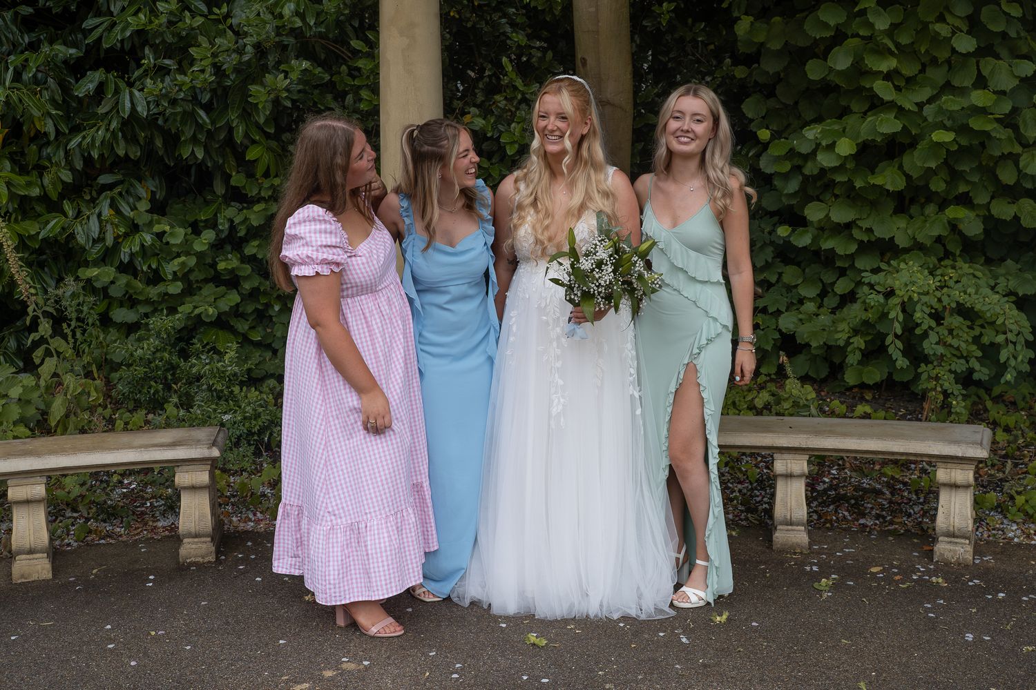 Bride with her bridesmaids laughing outside Champney treasure house, Beverley