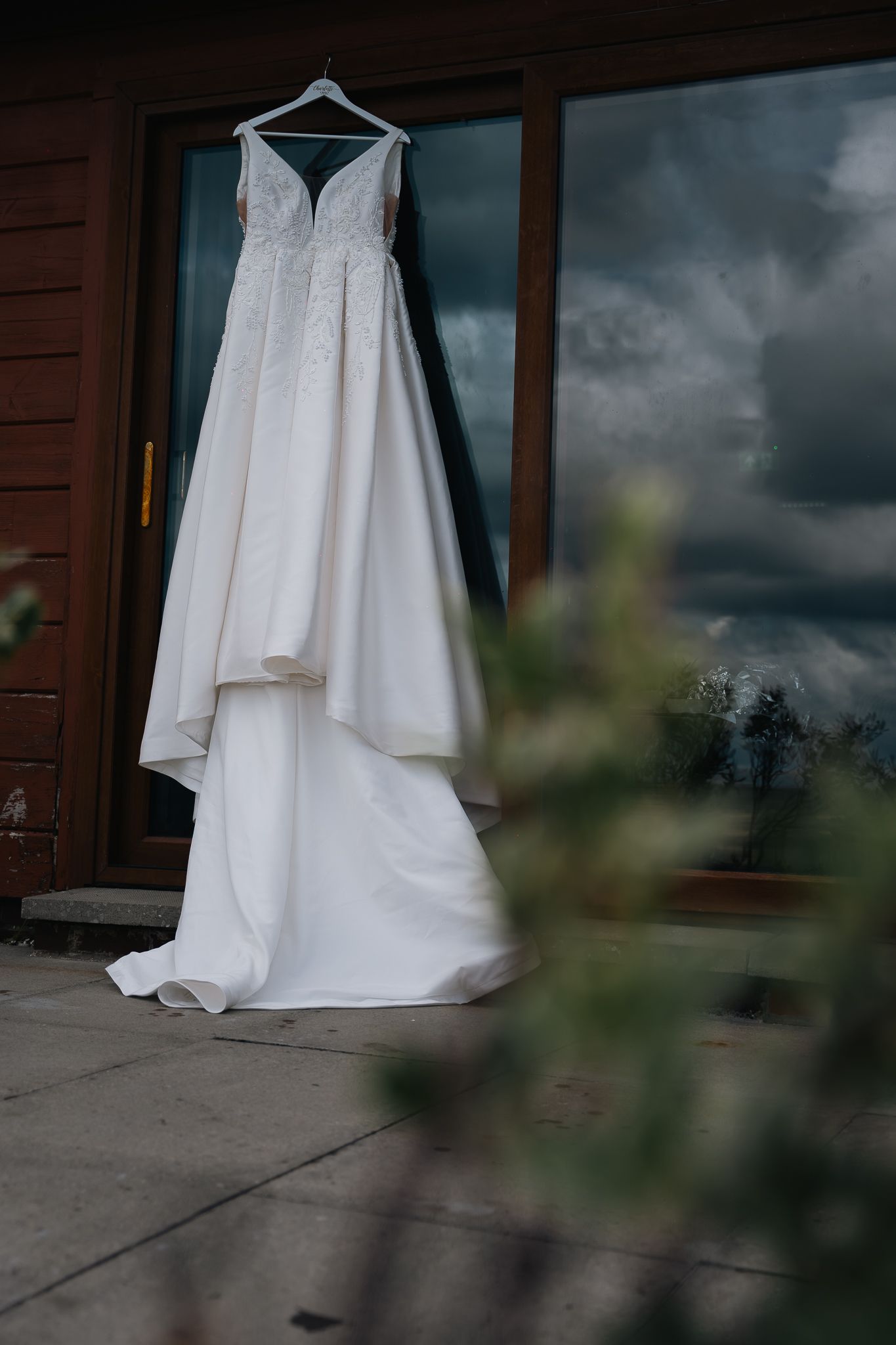 Brides dress hung up during the preparations at Grand villa heights in North Yorkshire, Taken by a Yorkshire documentary Photographer