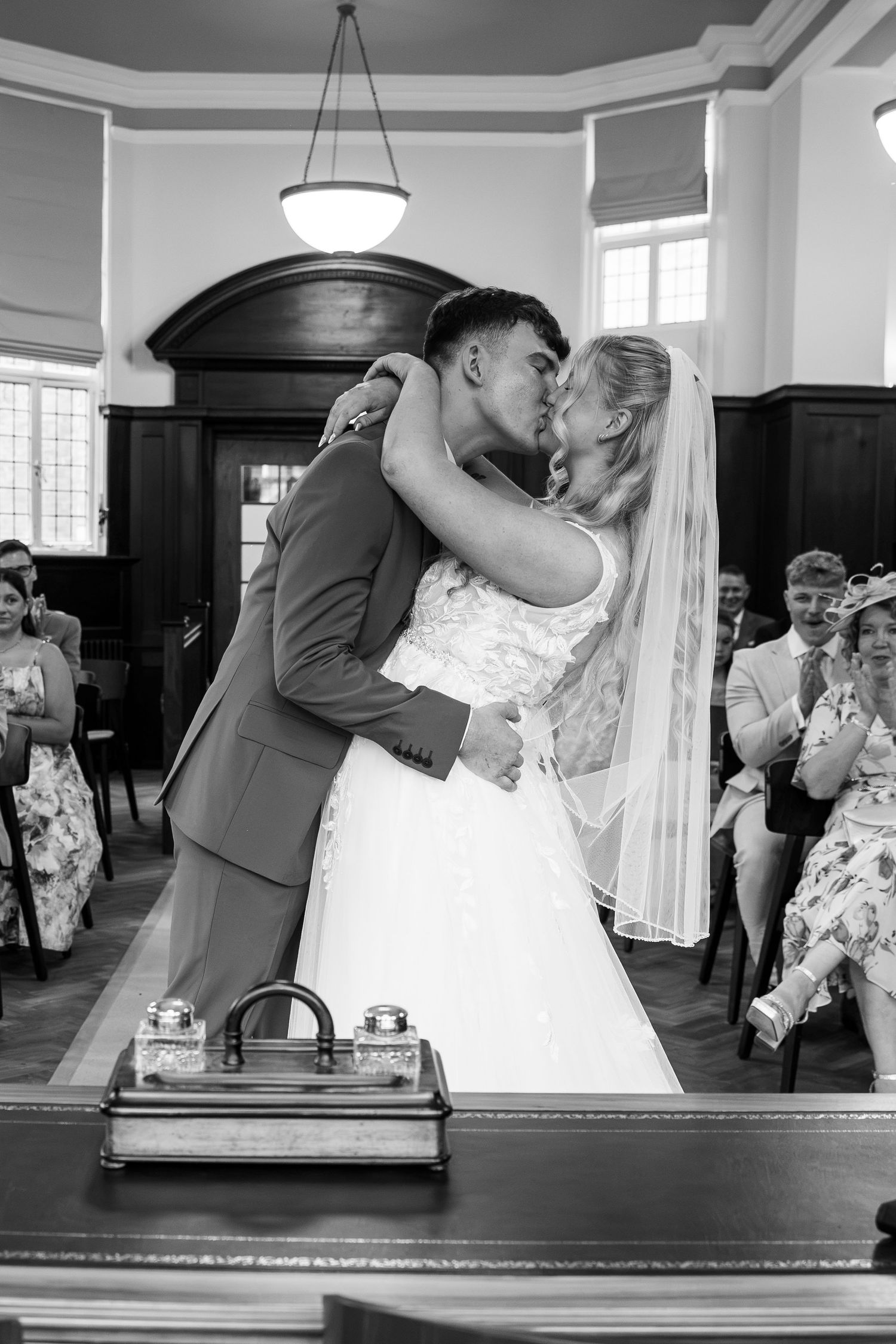 Black and white photo of a bride and groom sharing their first kiss at a wedding ceremony At Champney house in Beverley East Yorkshire