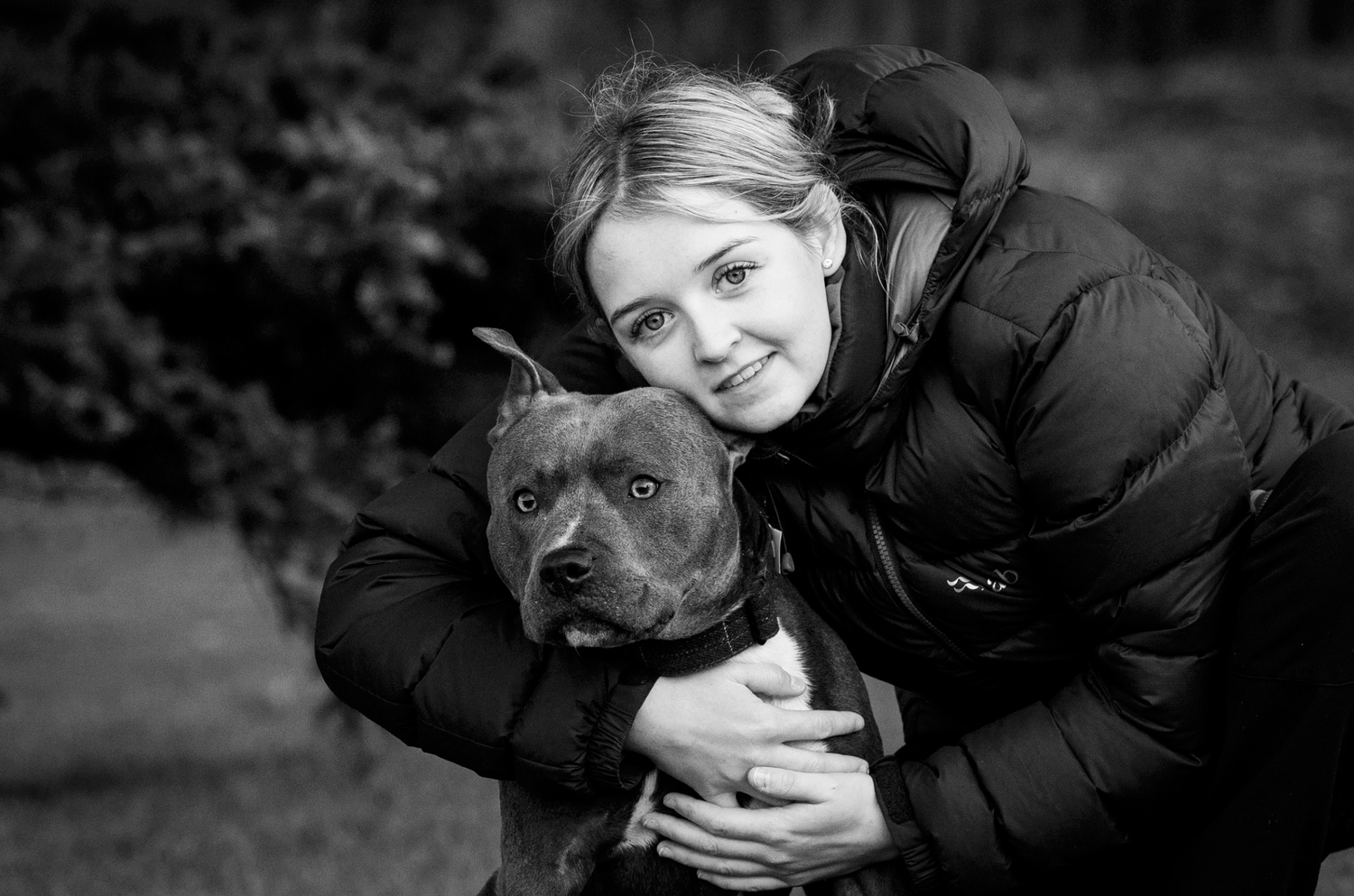 human cuddling dog