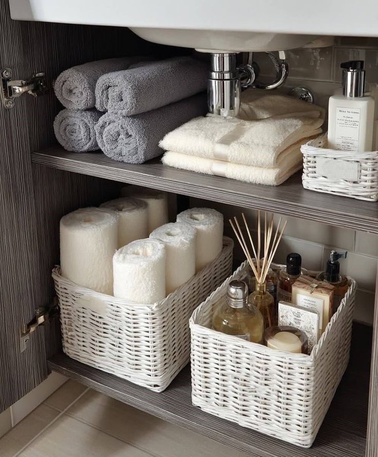 Bathroom organisation and cleaning in Canberra. Tidy baskets under the sink. Towels organised in the bathroom under the sink
