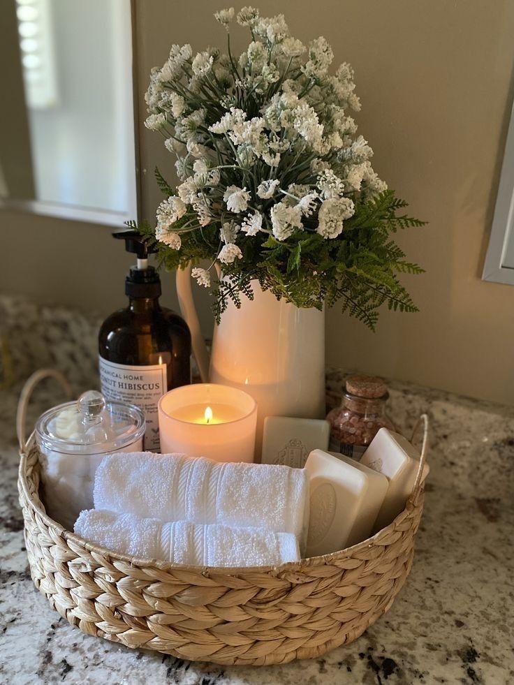 Bathroom organisation and cleaning in Canberra. Tidy basket on the bathroom counter. Towels organised in the basket with a scented candle.