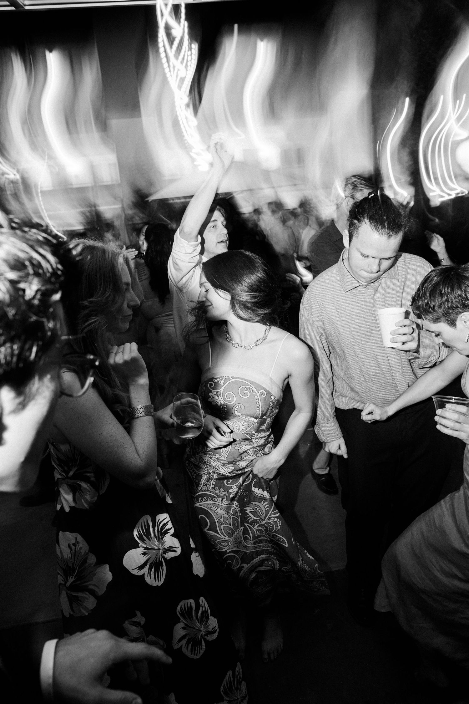 High-energy documentary wedding reception moment with guests dancing