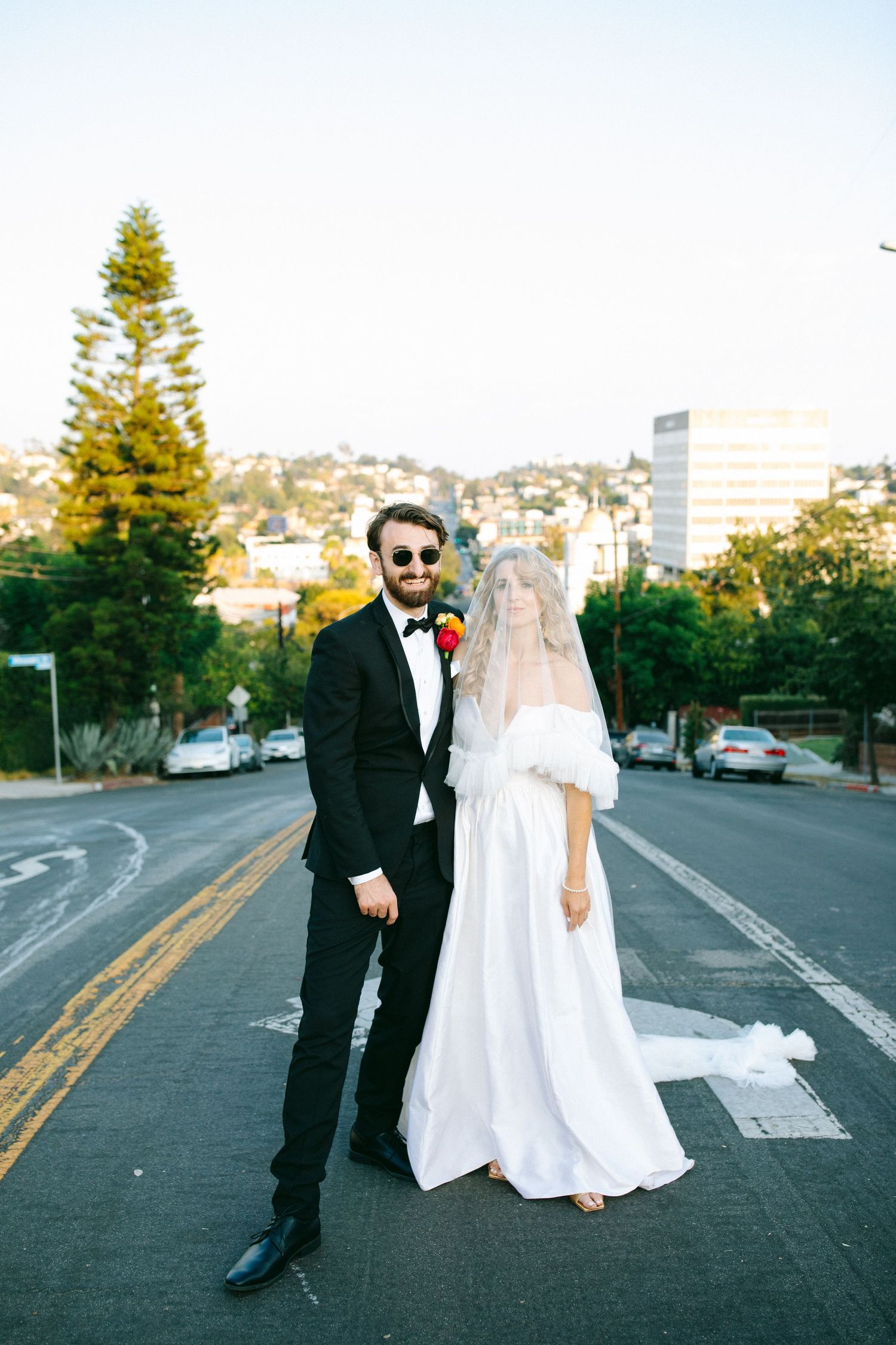 Bride and groom standing together in the street after their wedding ceremony