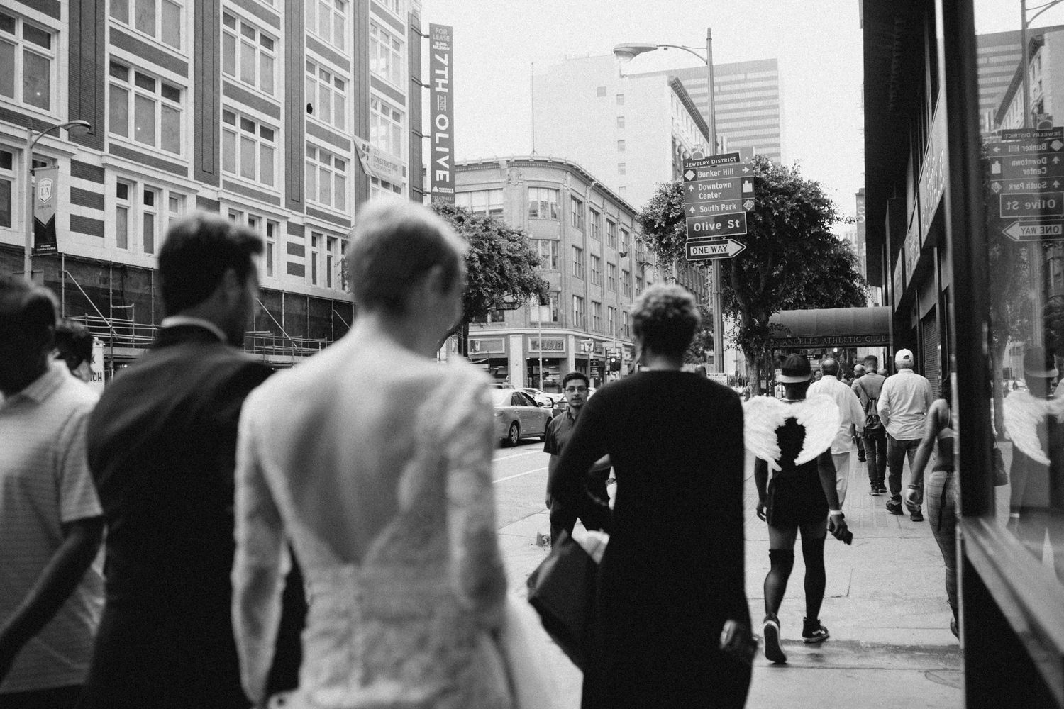 Unscripted moment of bride and groom walking together through the city