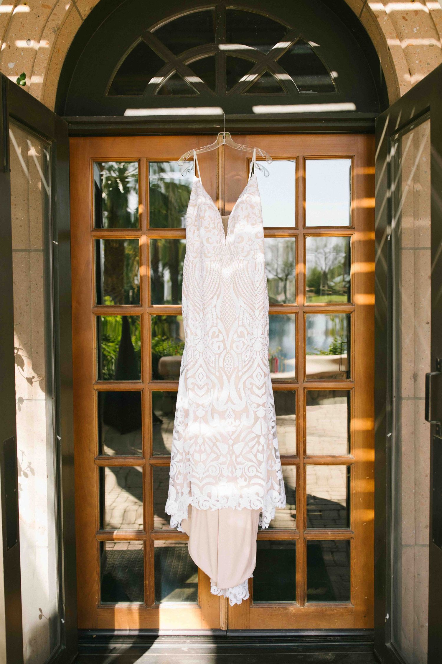 Wedding dress hanging in natural light before the ceremony