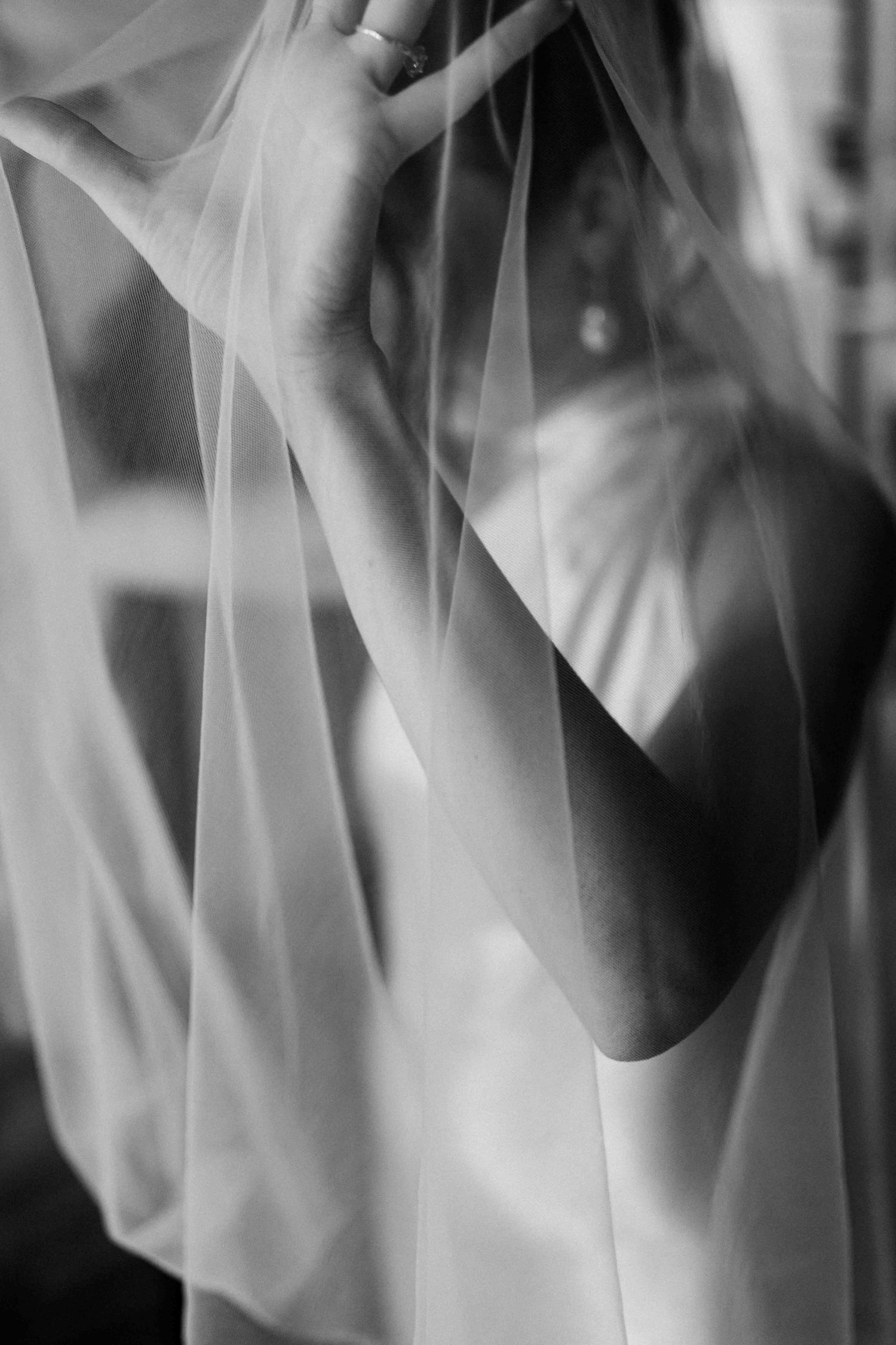 Artistic documentary portrait of a bride through her veil