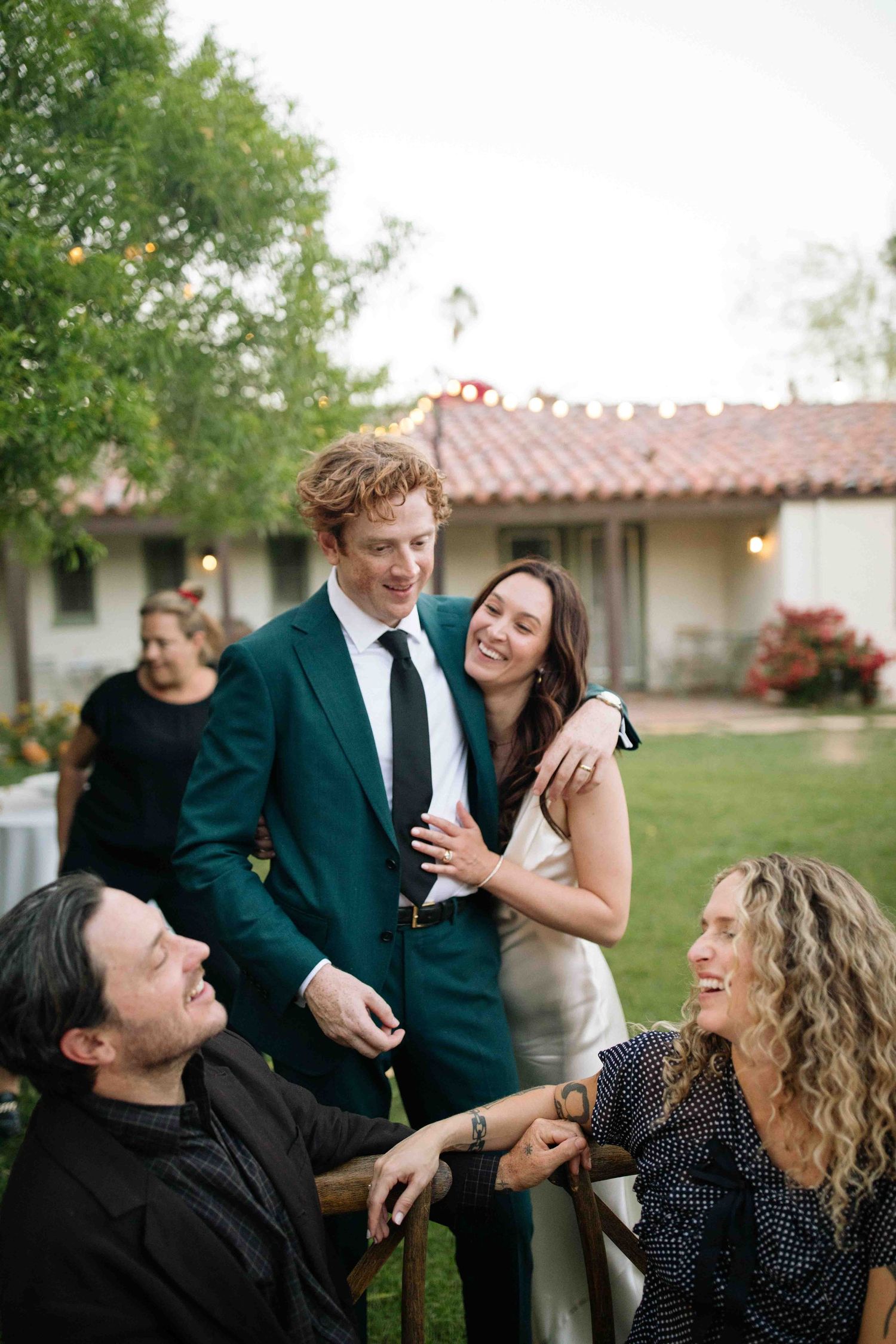 Wedding guests and a couple celebrating together in a relaxed, documentary style