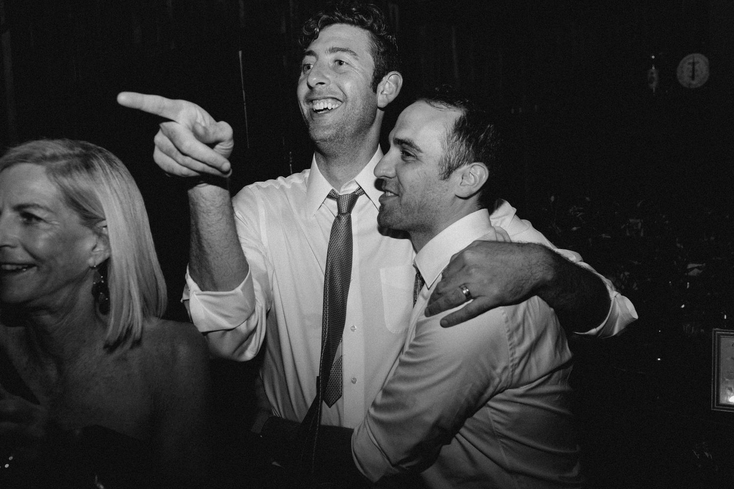 Candid reception moment of wedding guests laughing together