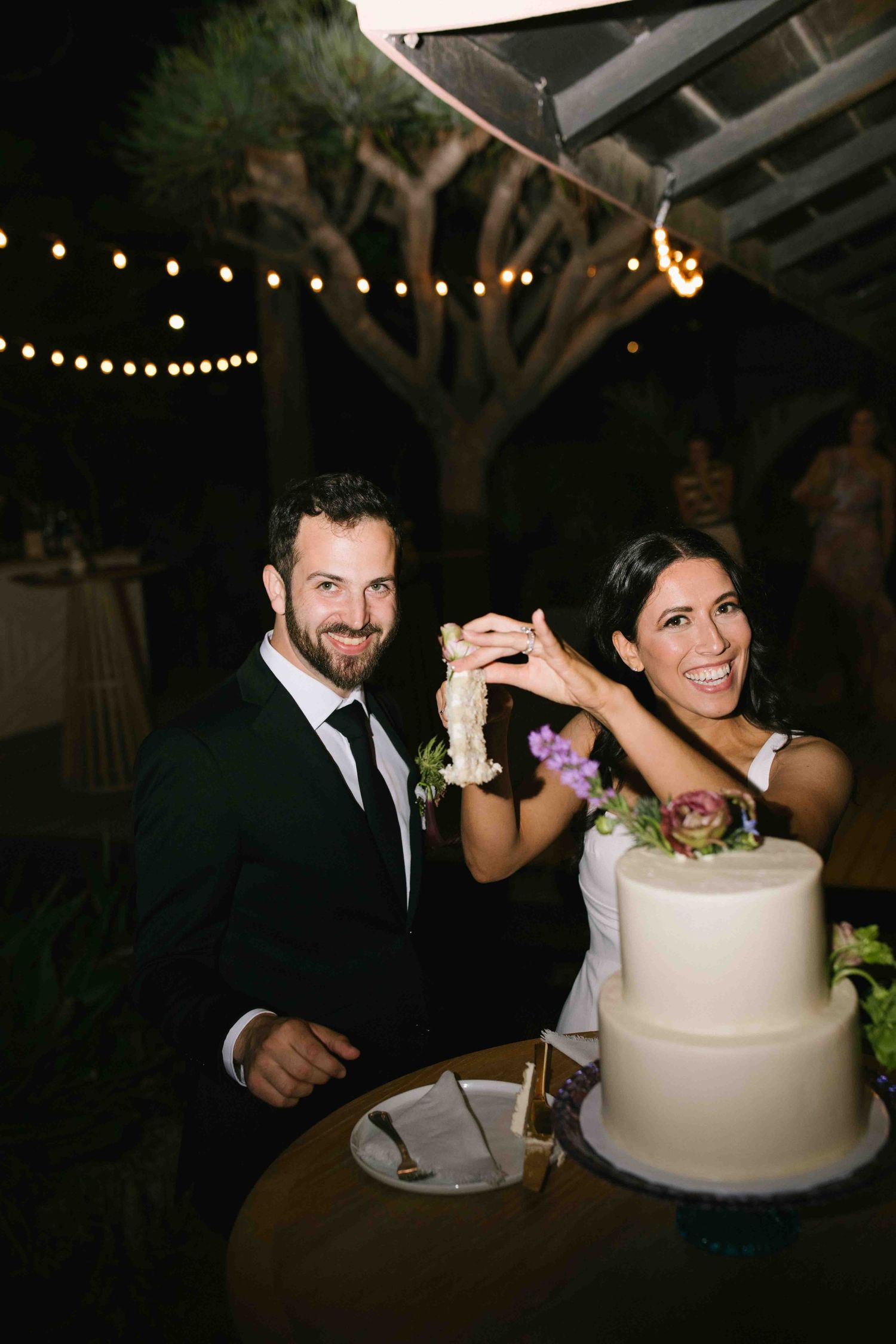 Unscripted cake cutting moment during a wedding reception