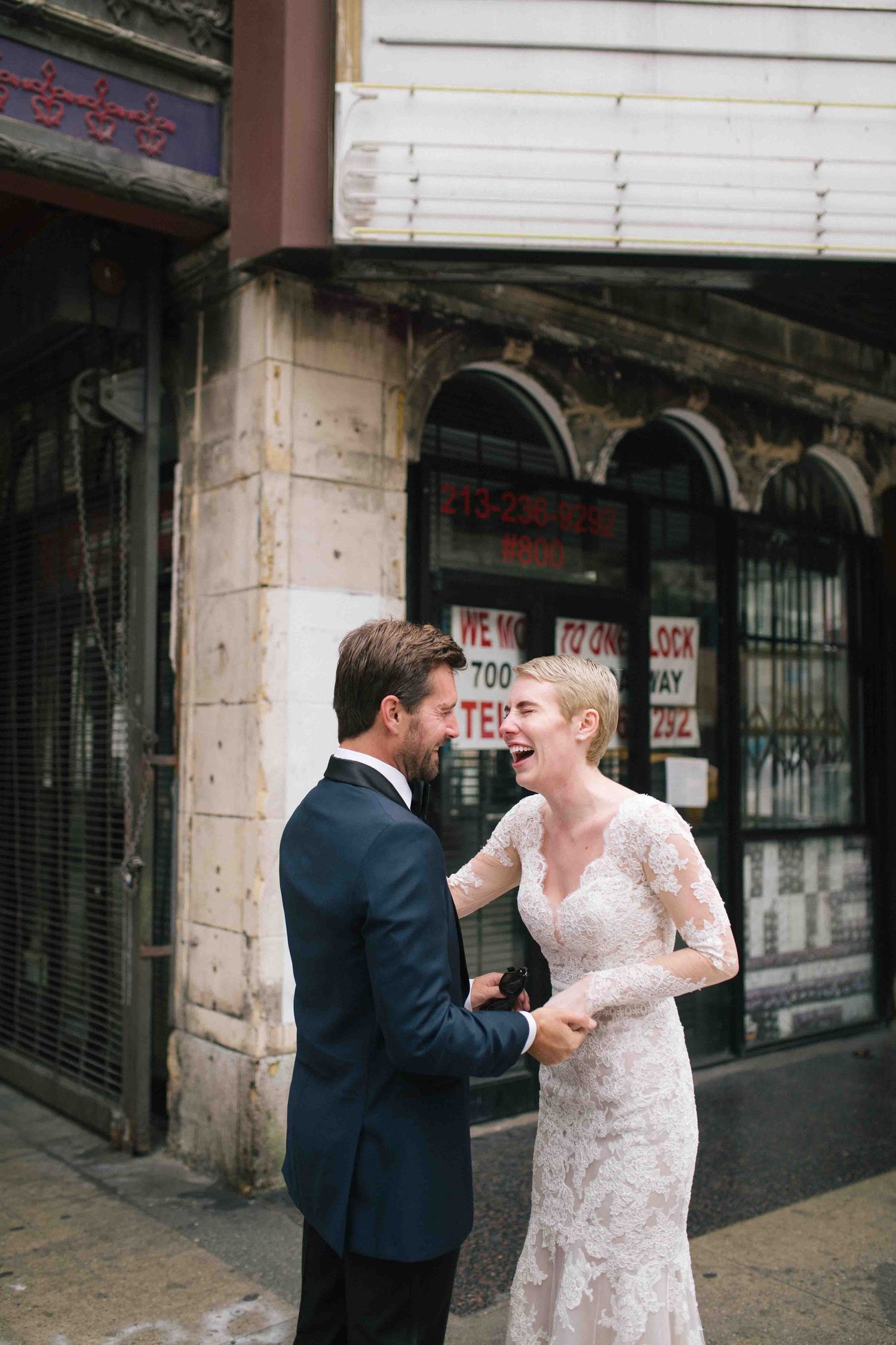 Candid wedding moment of a couple first look, talking together outside their venue